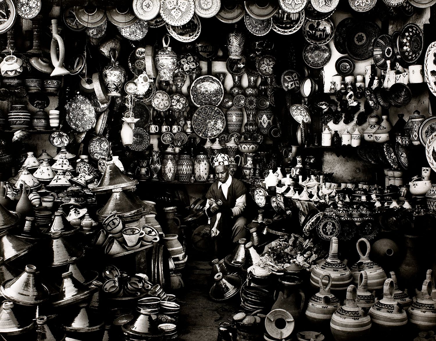 Shopkeeper with Clay Pots in Marrakech