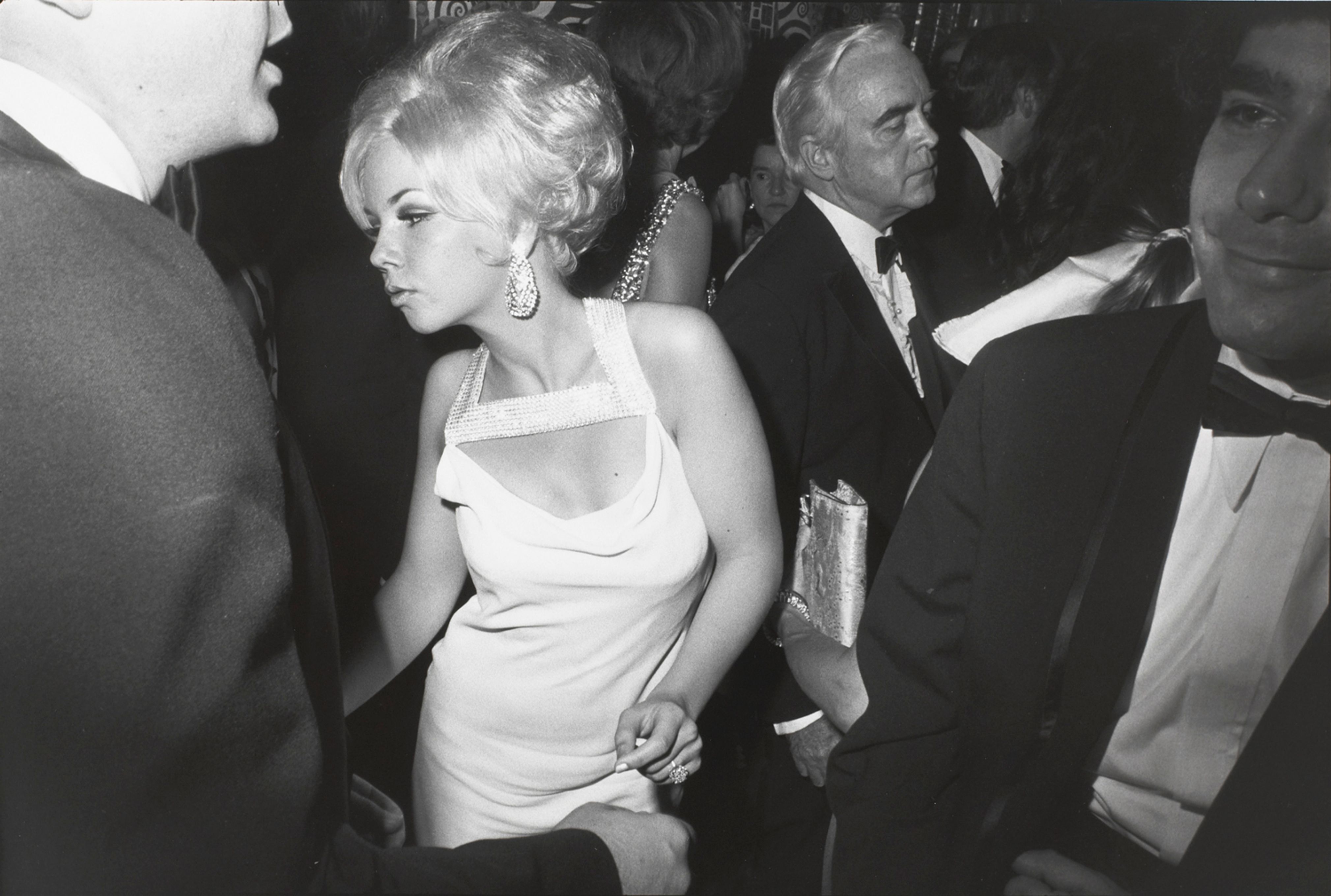 Untitled (Blond woman dancing, she has a rhinestone studded collar on her dress)