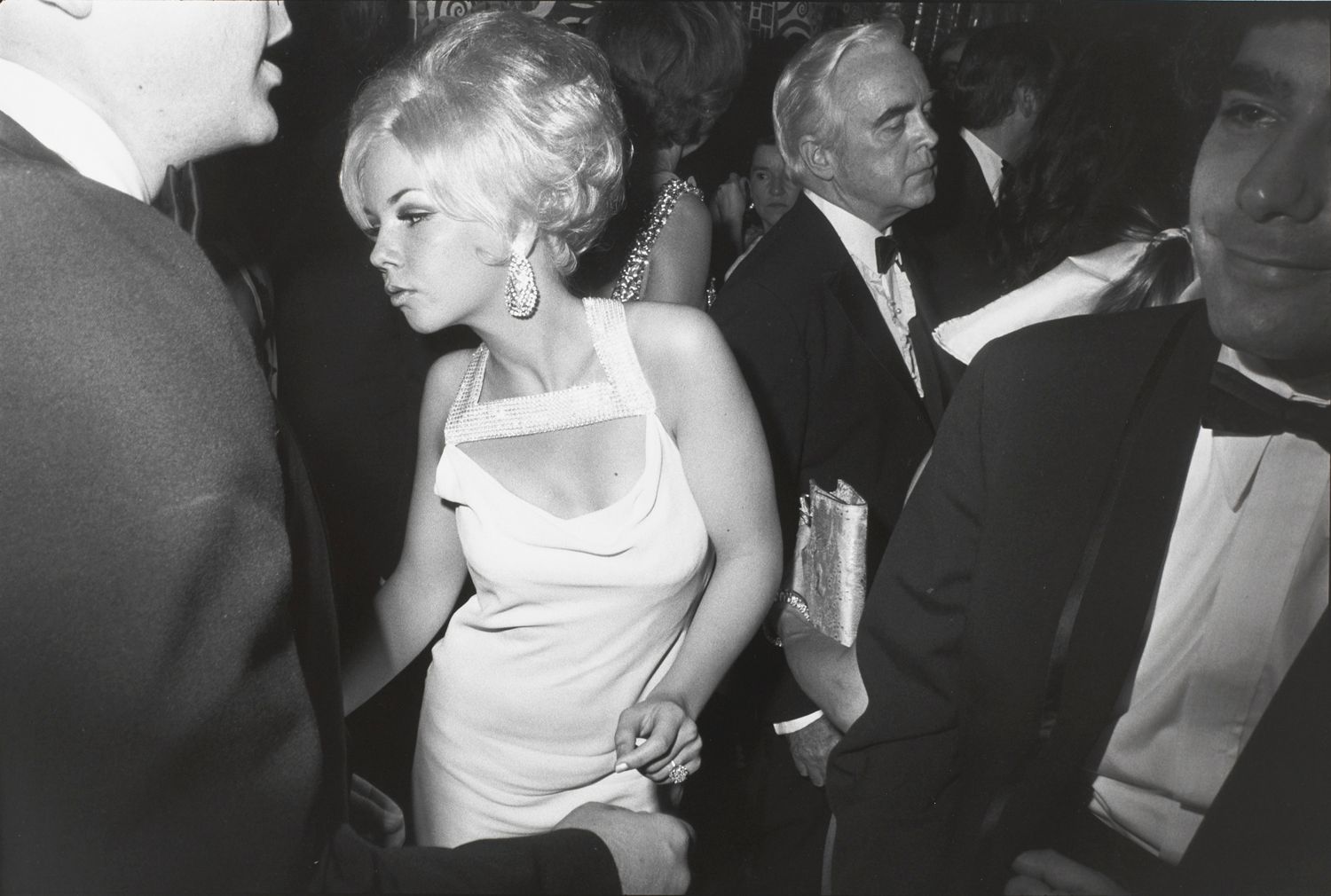 Untitled (Blond woman dancing, she has a rhinestone studded collar on her dress)