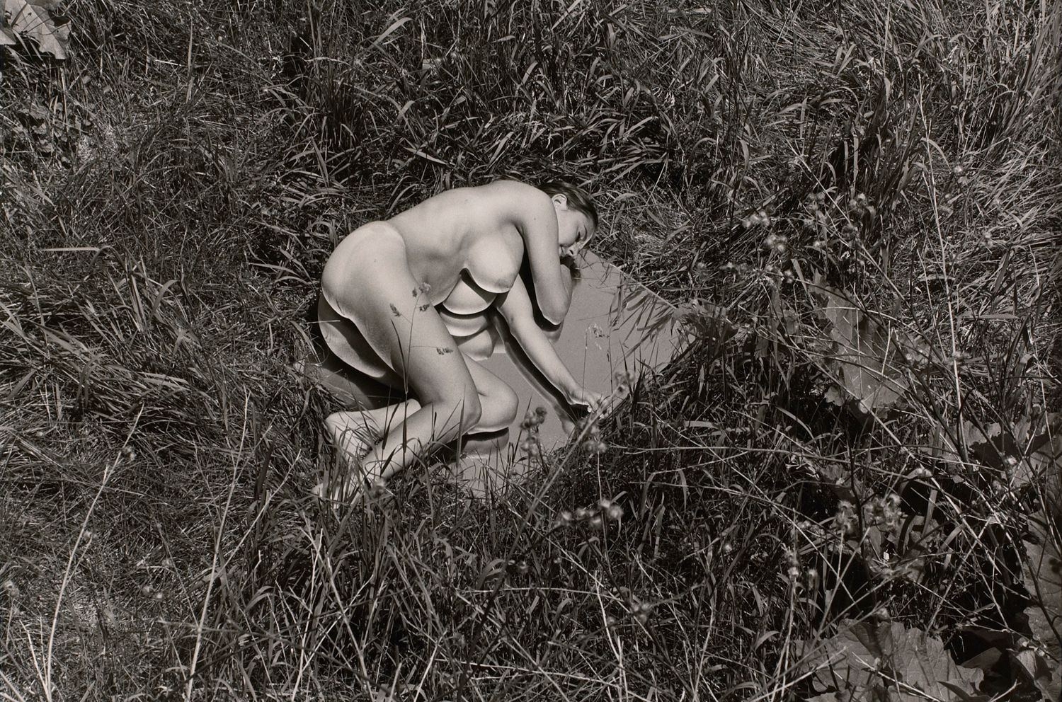 Untitled: Woman Laying On Mirror in the Grass I