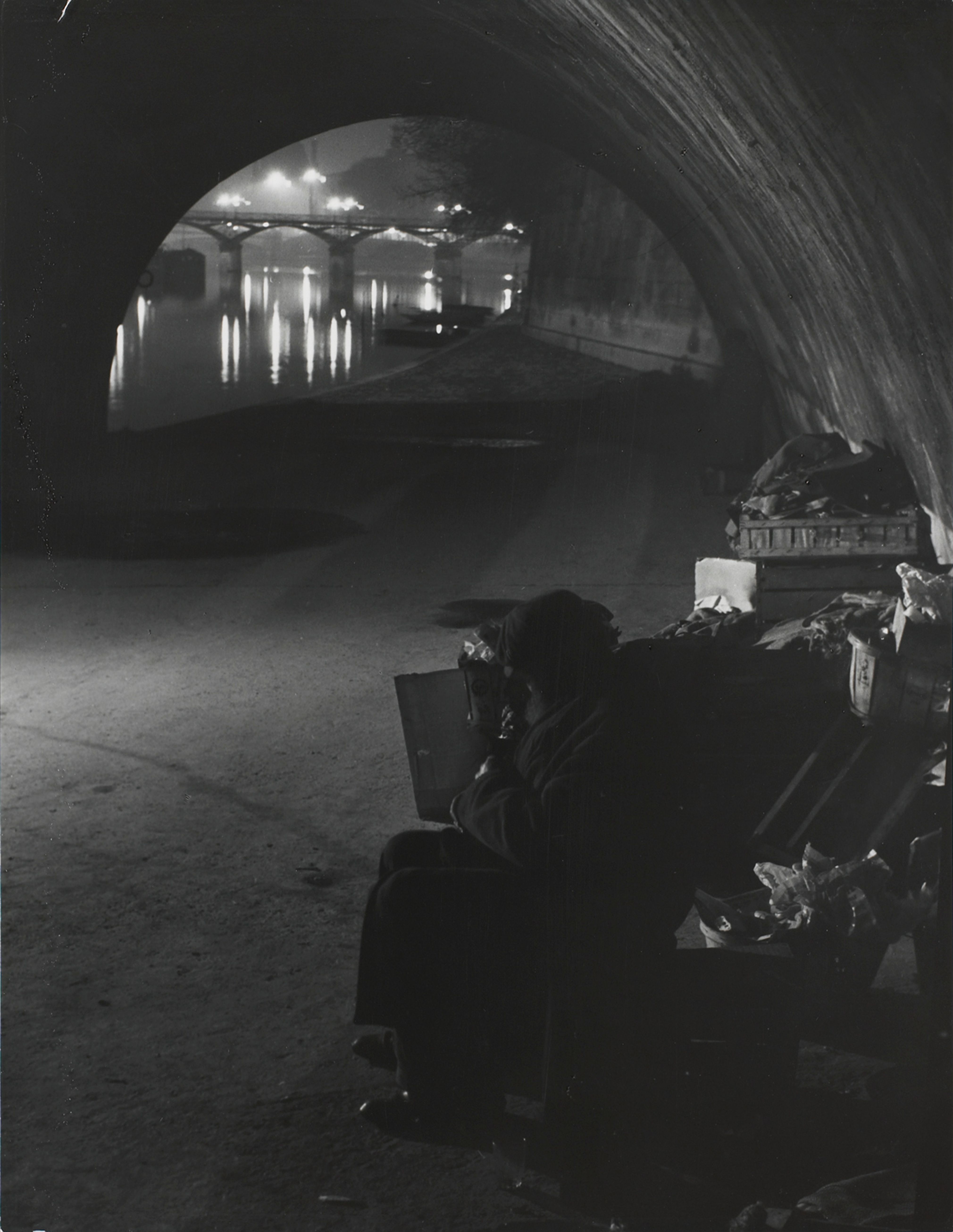 Clochards under the Pont-Neuf. In the distance, the Pont des Arts