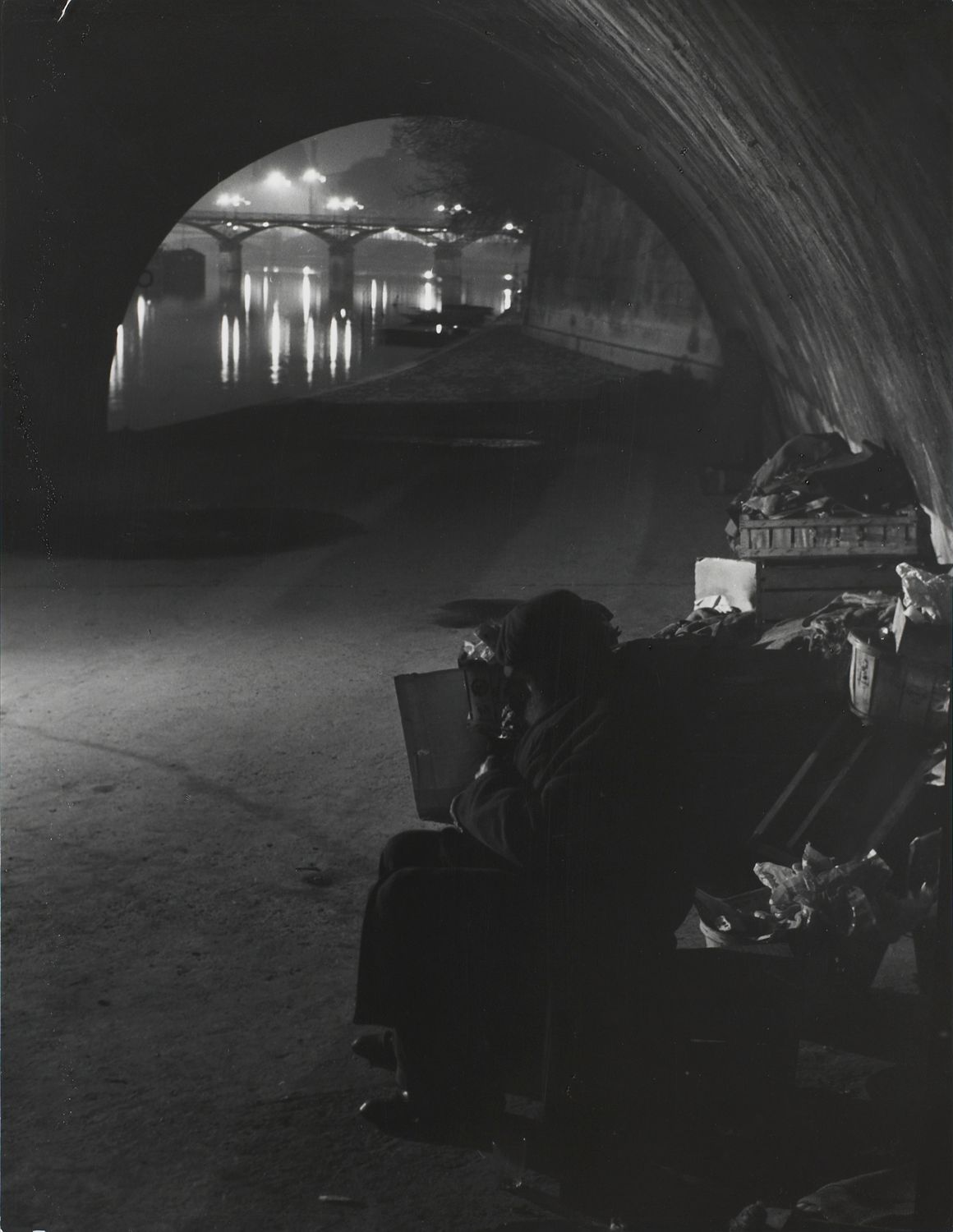 Clochards under the Pont-Neuf. In the distance, the Pont des Arts