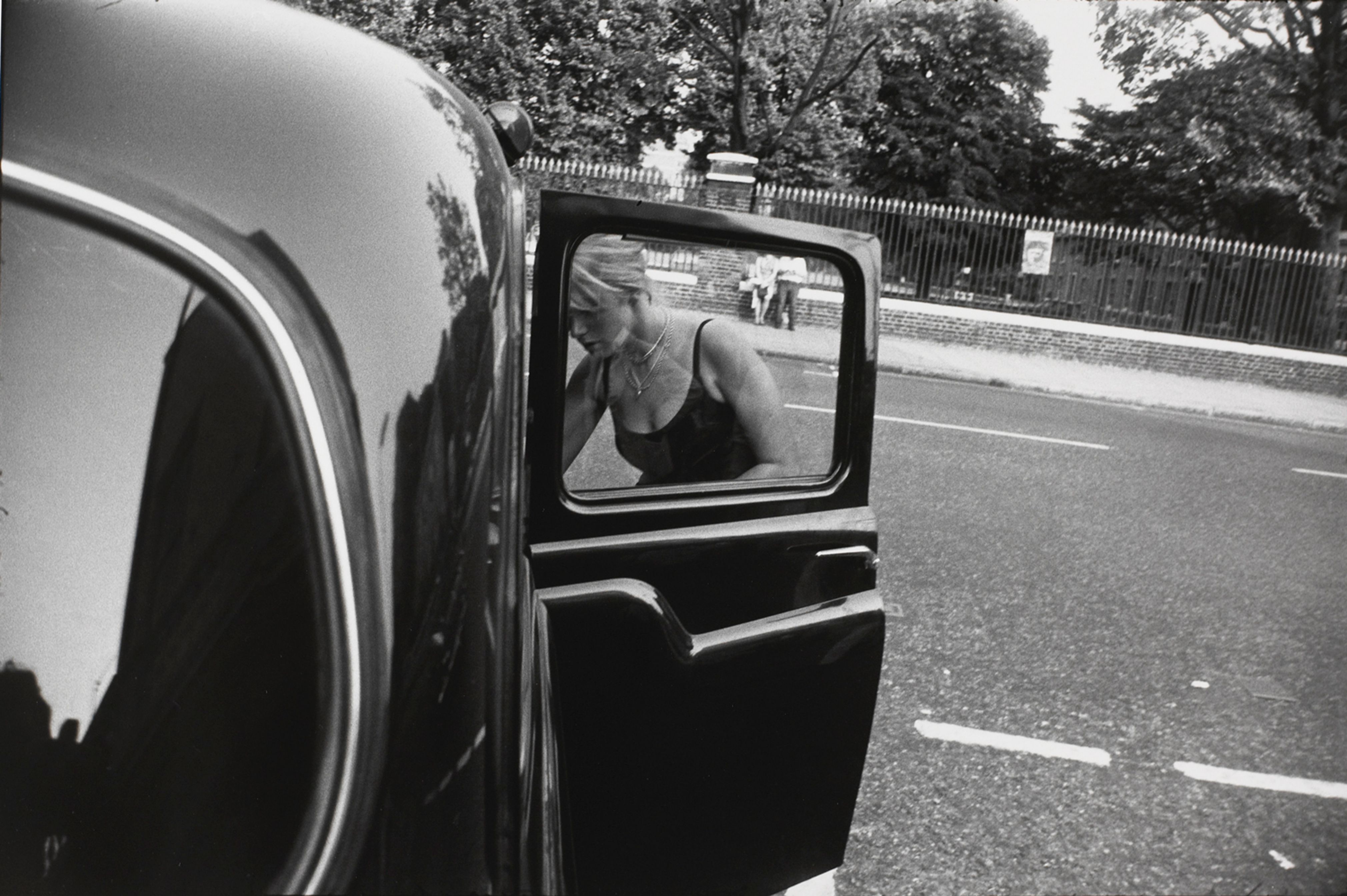 Untitled (Woman leaning into a black car)