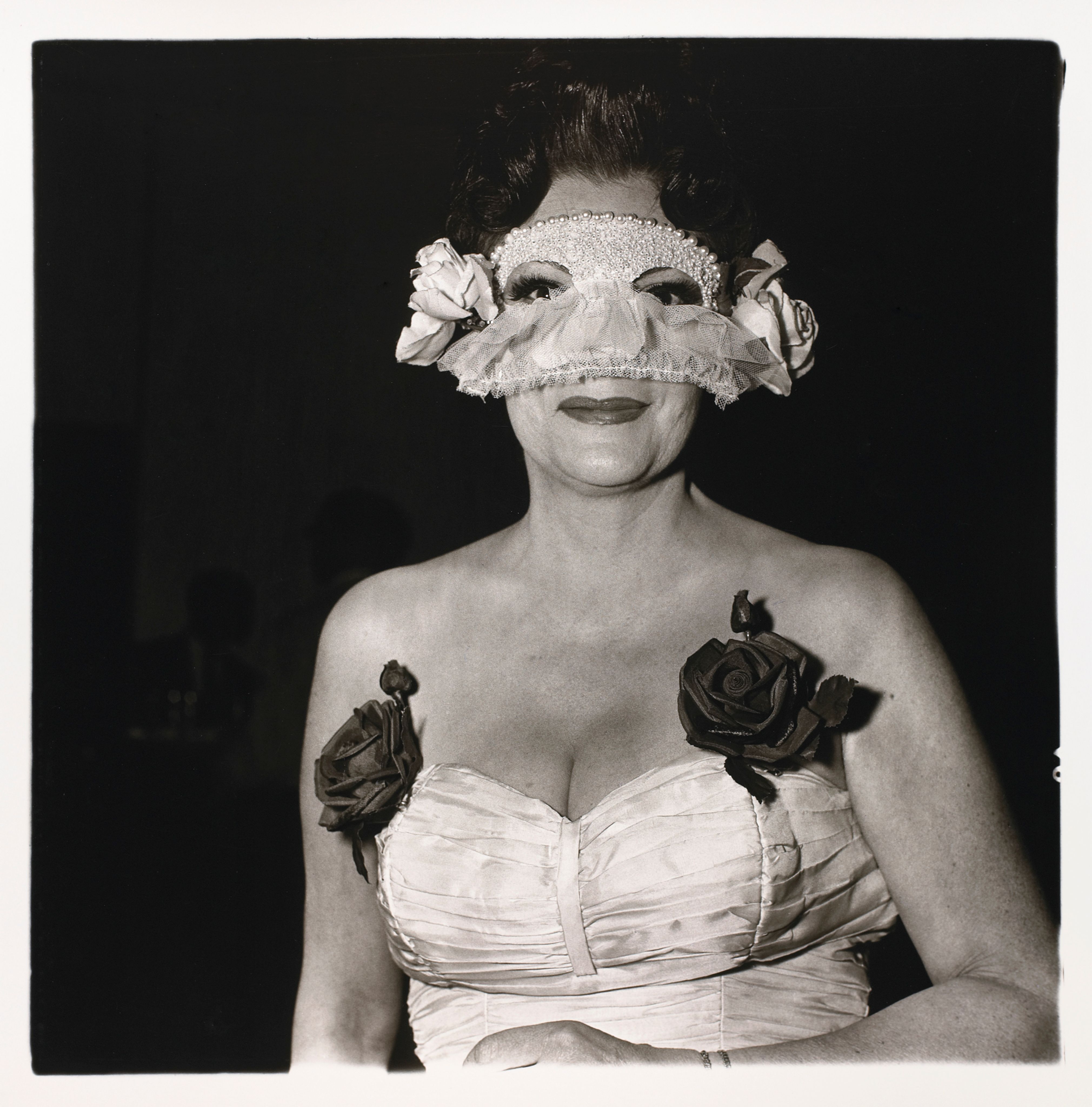 Lady at a masked ball with two roses on her dress, N.Y.C.