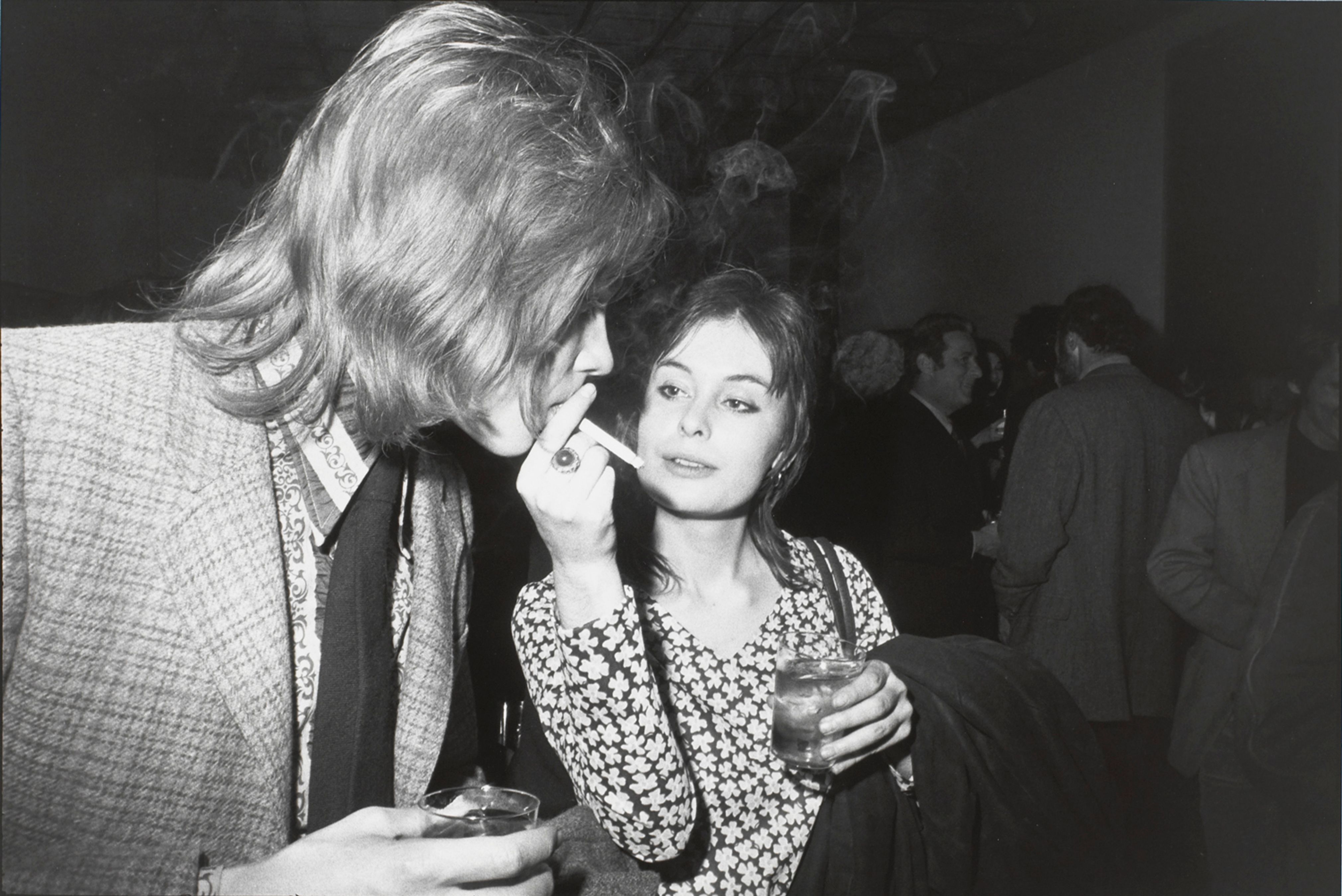 Untitled (Woman holding a cigarette while a man takes a puff)