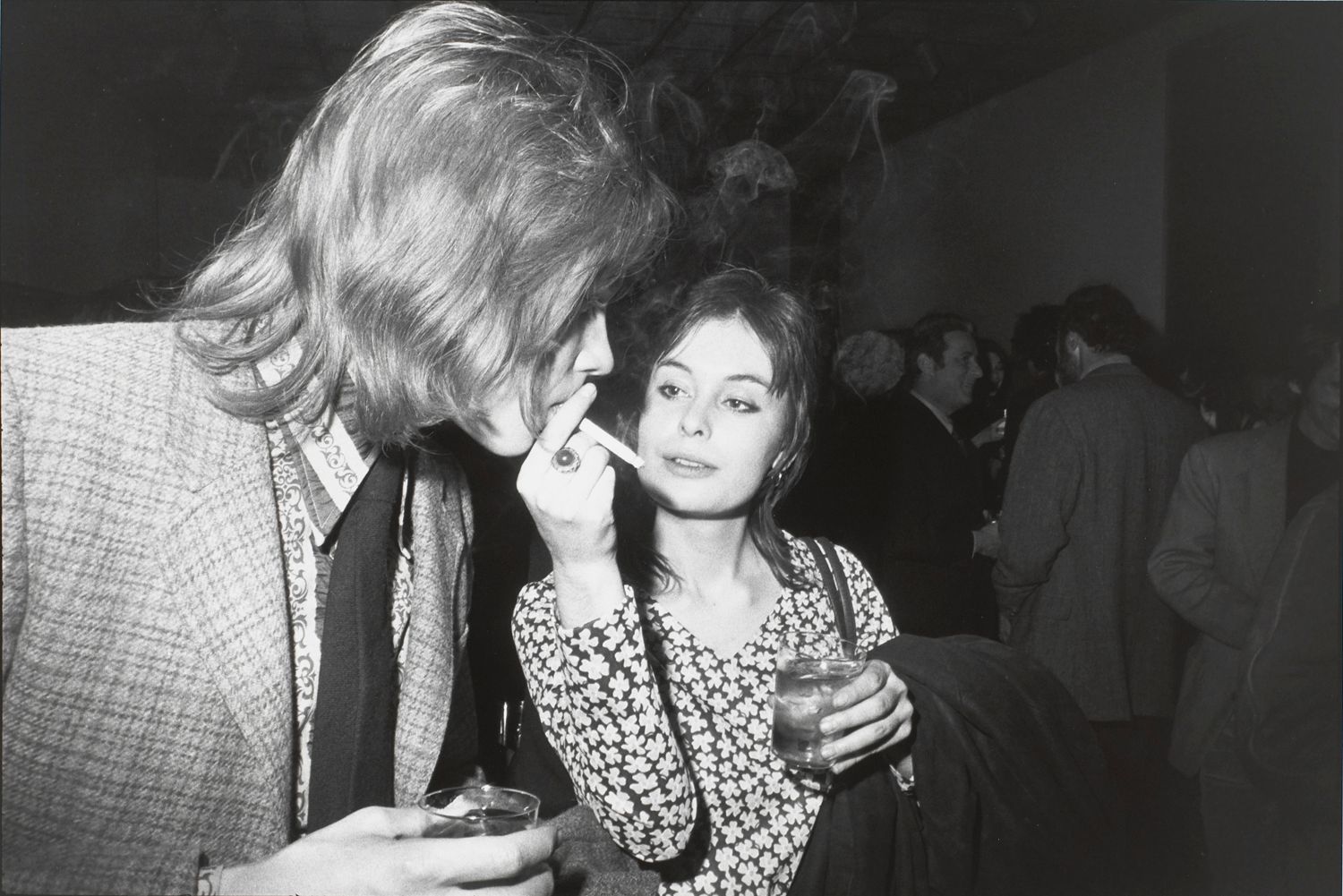 Untitled (Woman holding a cigarette while a man takes a puff)
