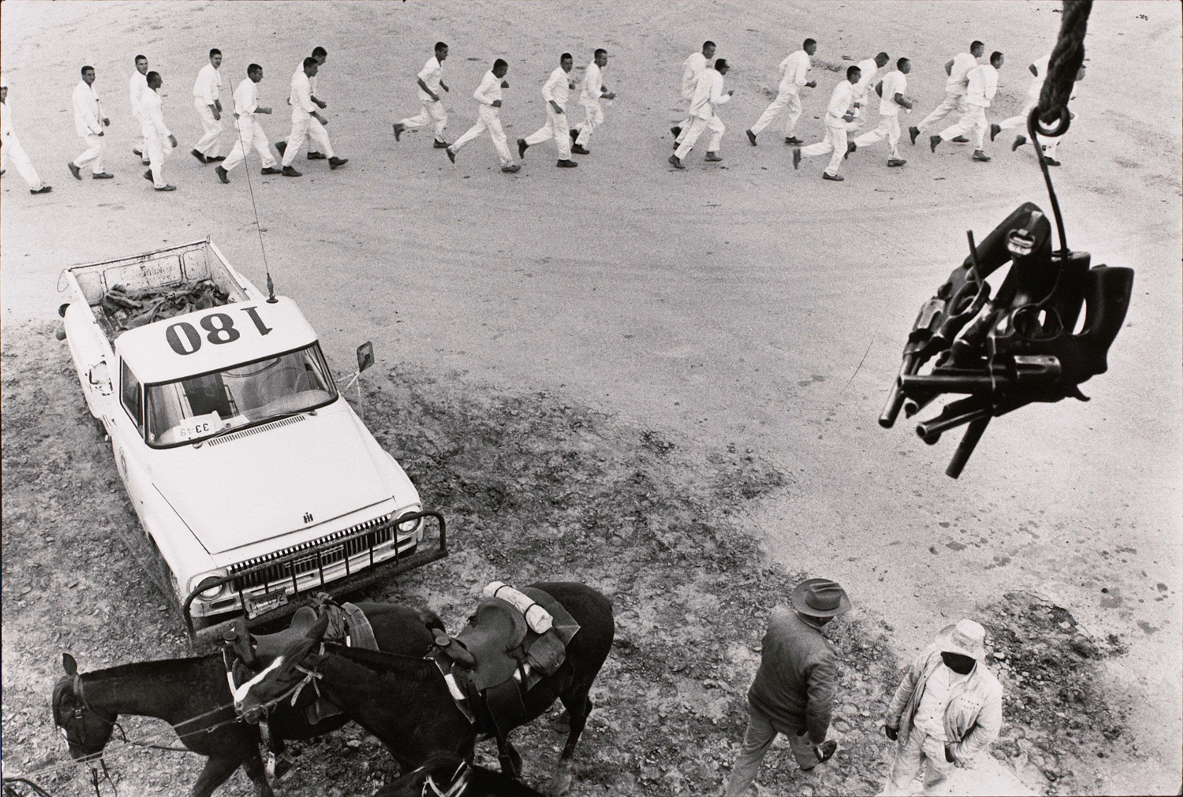 Guns are passed to the picket tower; the line returns from work