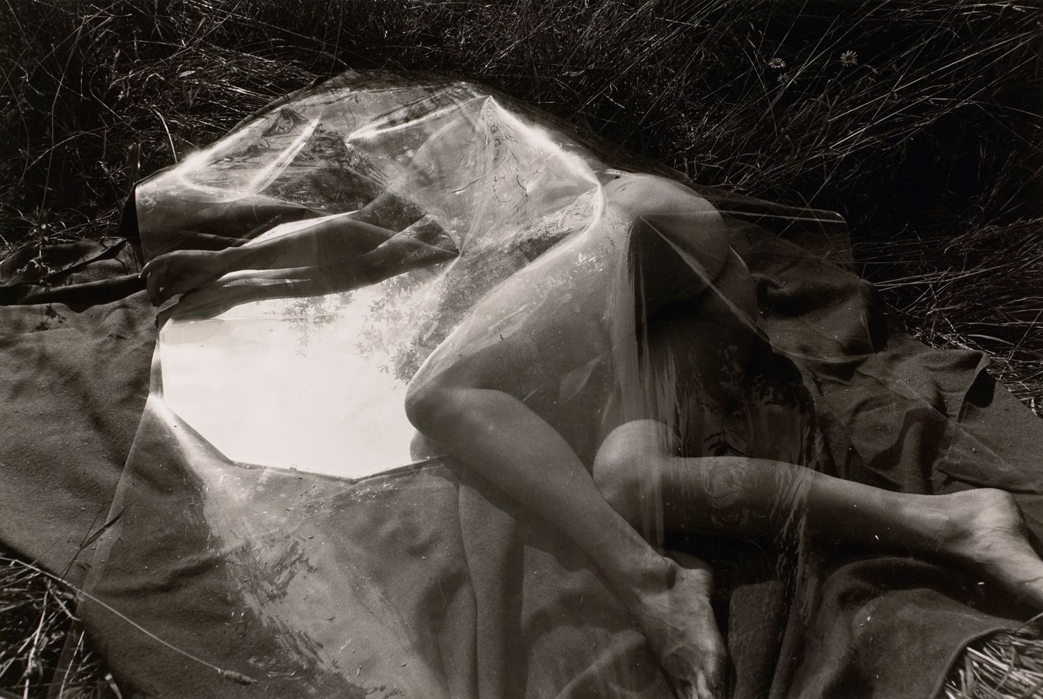 Untitled: Woman Resting Under Plastic with Mirror