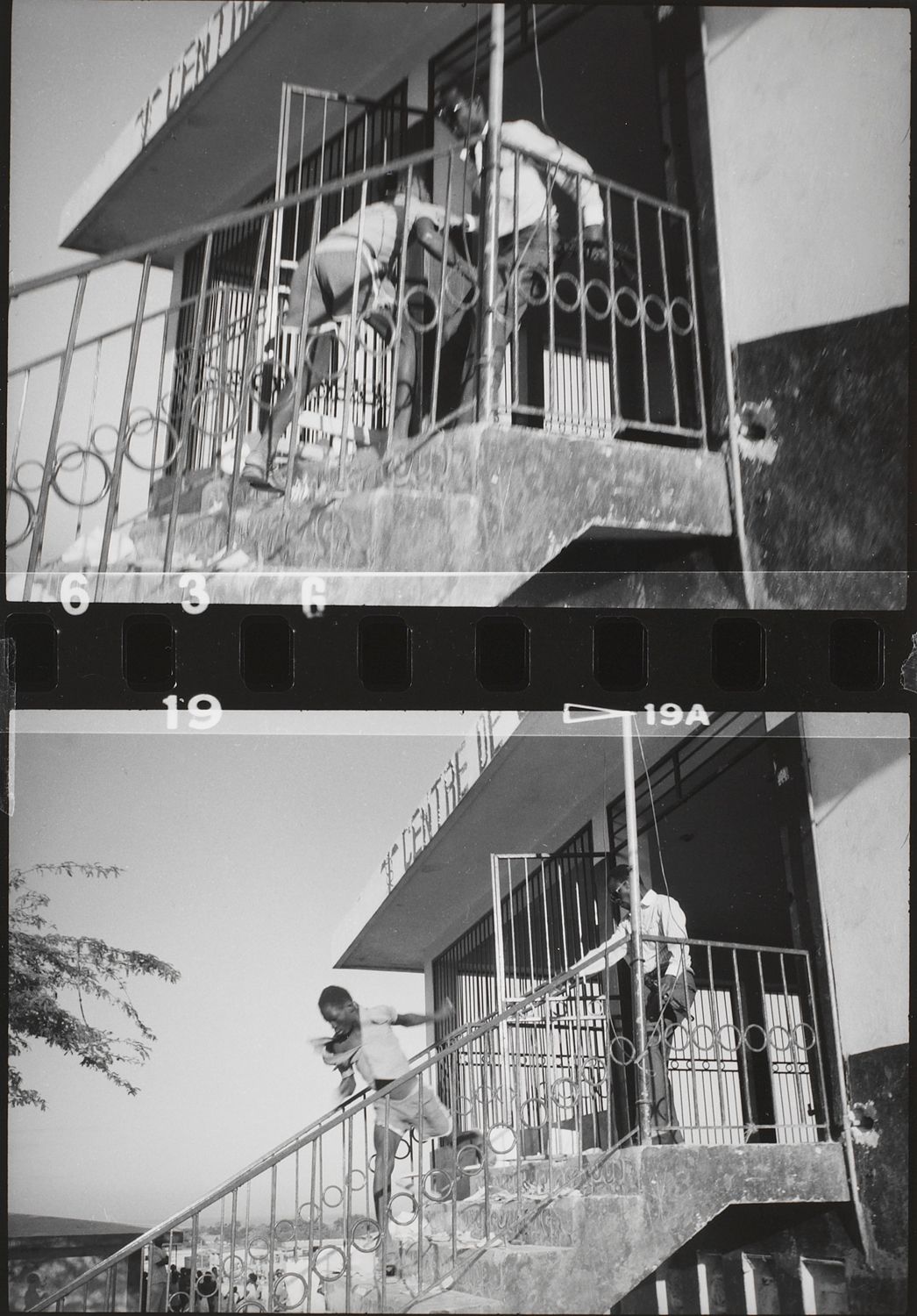 An out-of-uniform Tonton Macoute throws looter down a flight of stairs