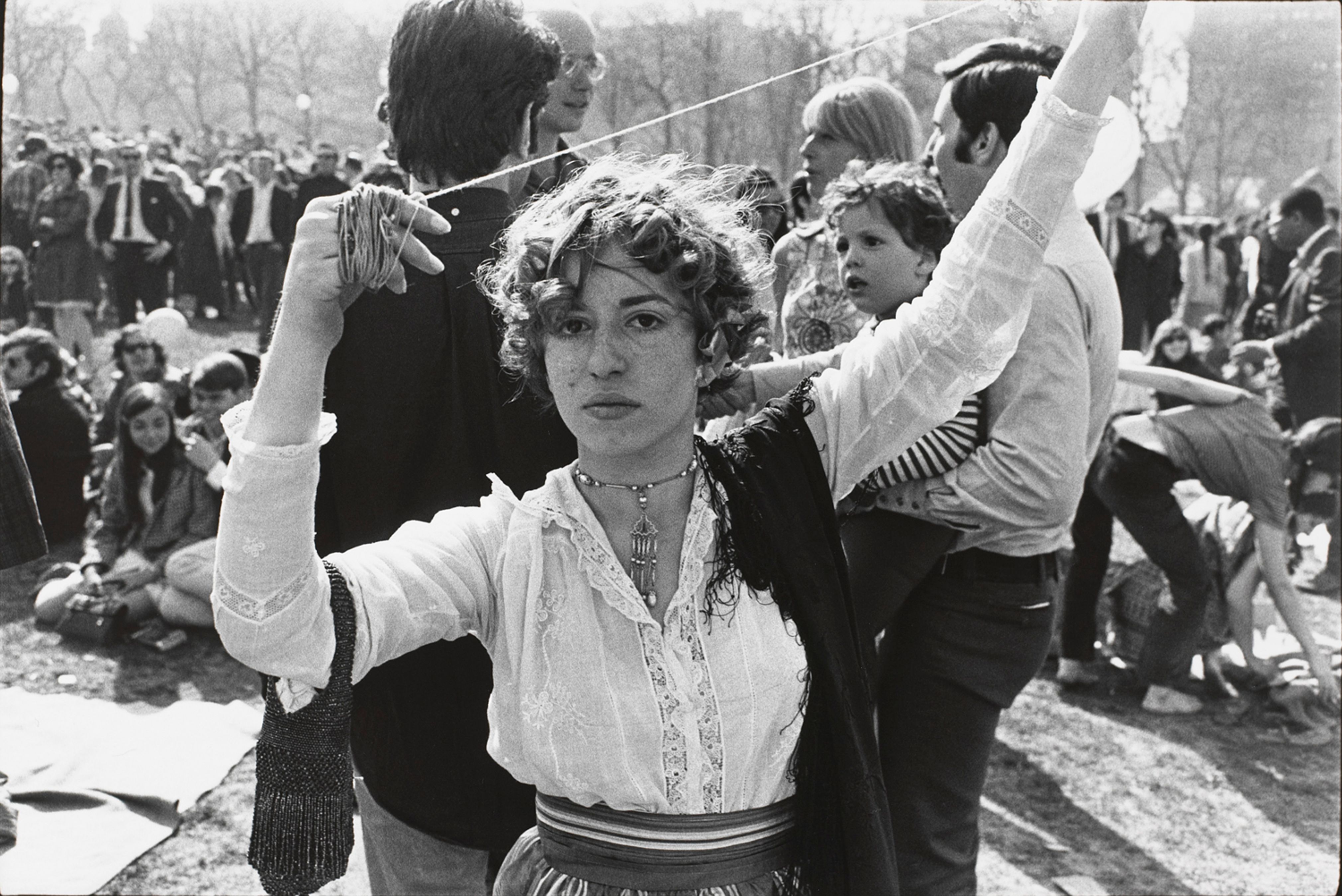 Untitled (Woman in lace blouse, arms raised with twine in her hands)