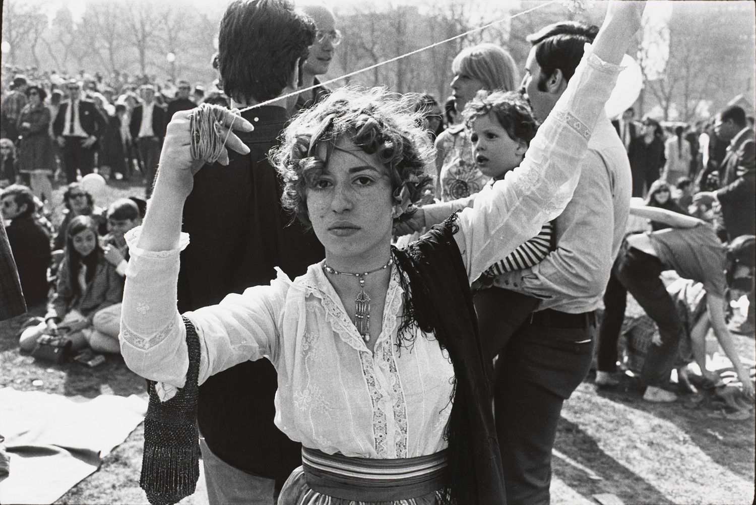 Untitled (Woman in lace blouse, arms raised with twine in her hands)