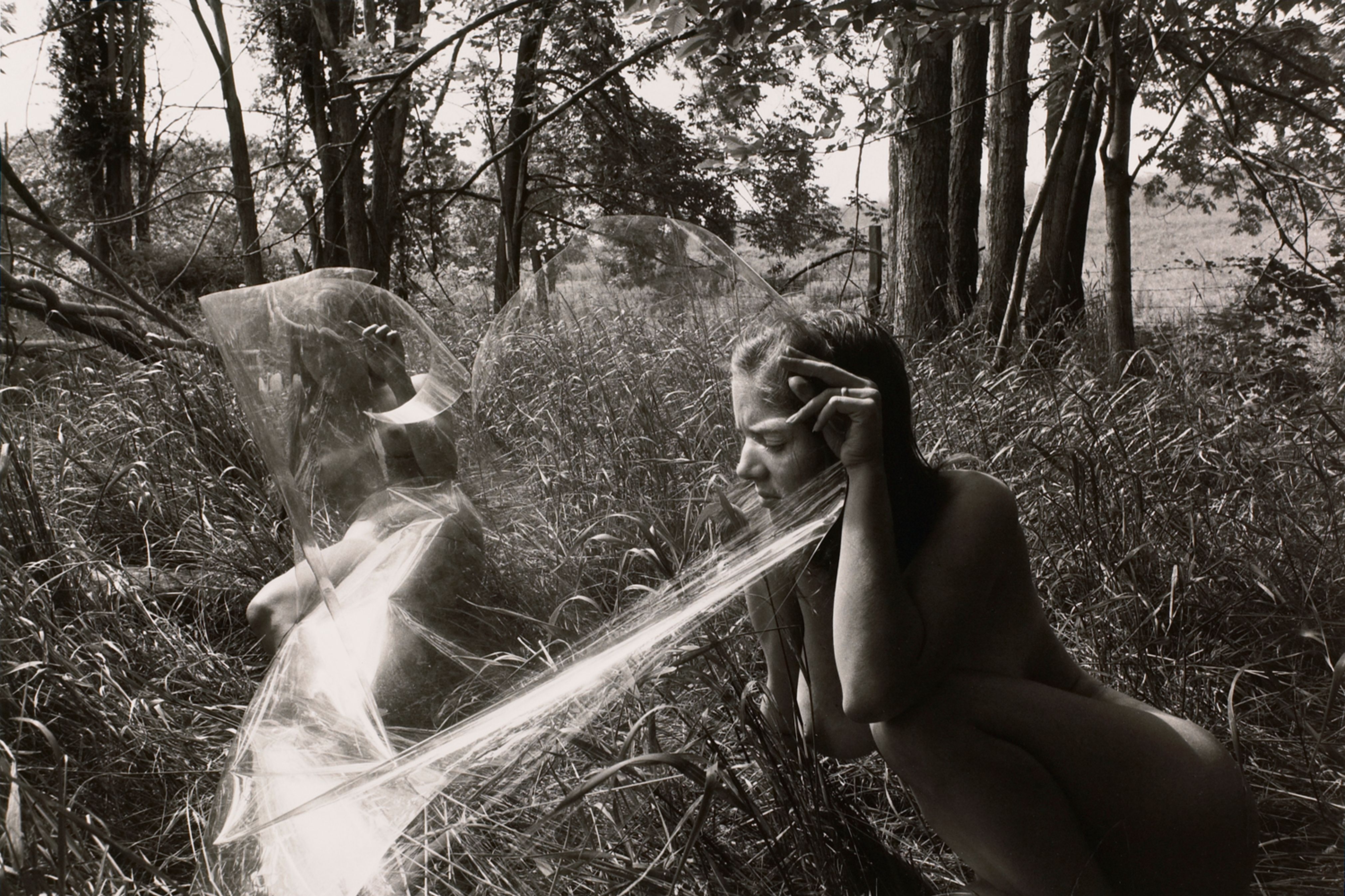 Untitled: Women Looking Through Plastic