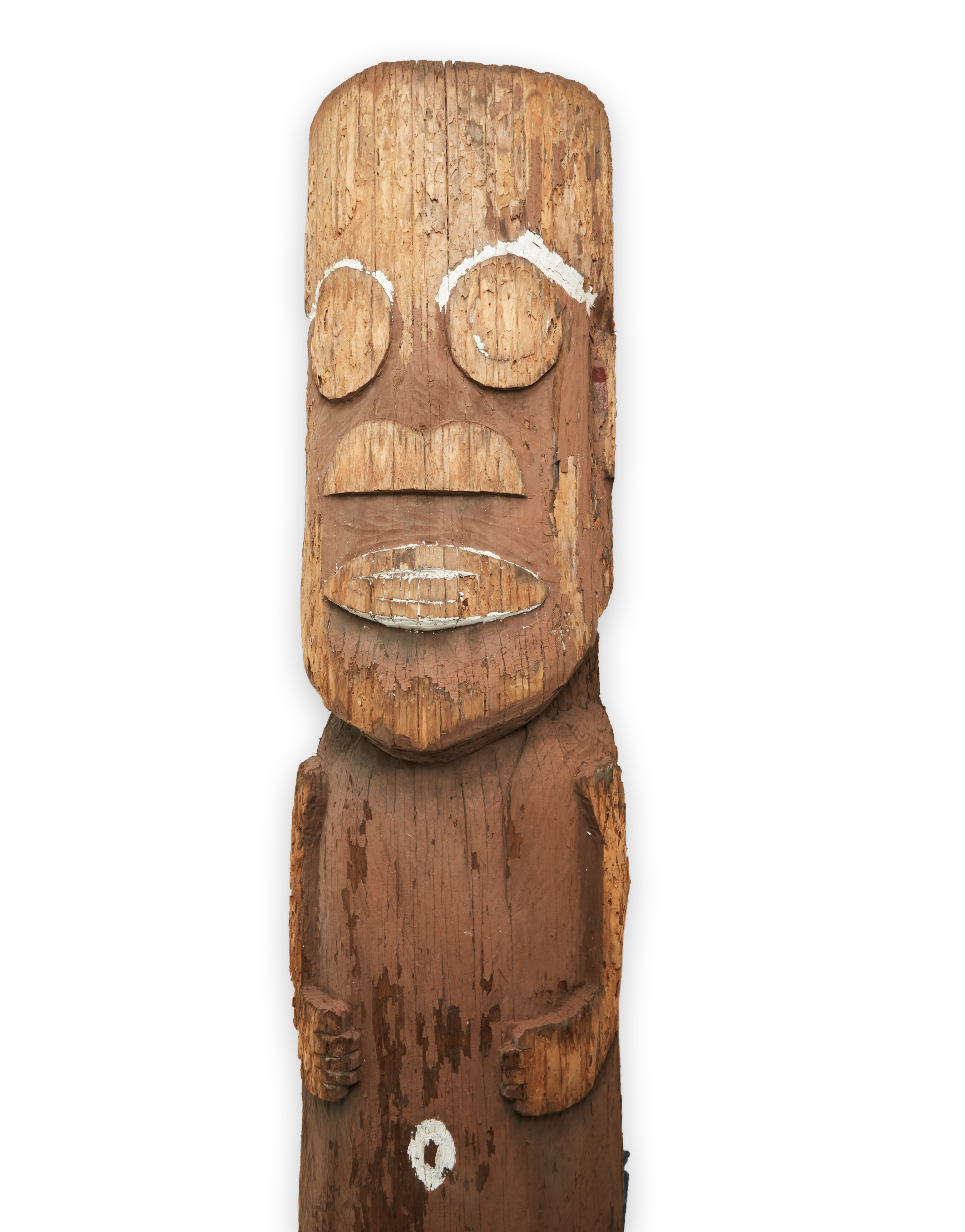 a wooden totem pole with a face carved into it