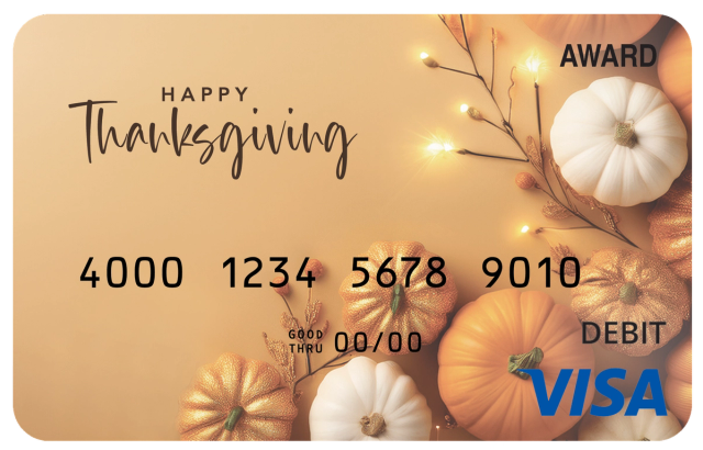 Award debit card with pumpkins, warm lights, and the message “Happy Thanksgiving.”