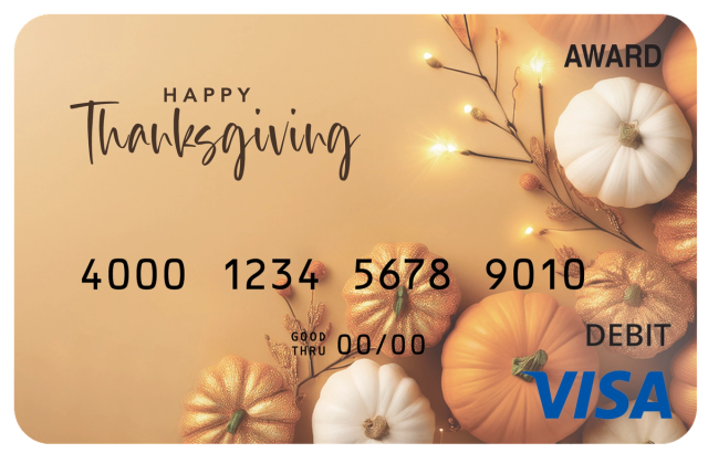 Award debit card with pumpkins, warm lights, and the message “Happy Thanksgiving.”