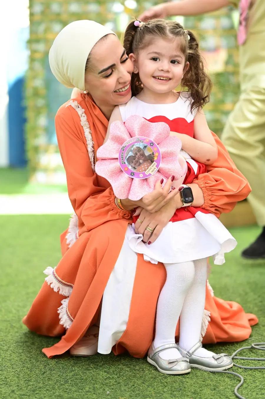 Mother hugging her daughter at a Belvedere British Nursery celebration