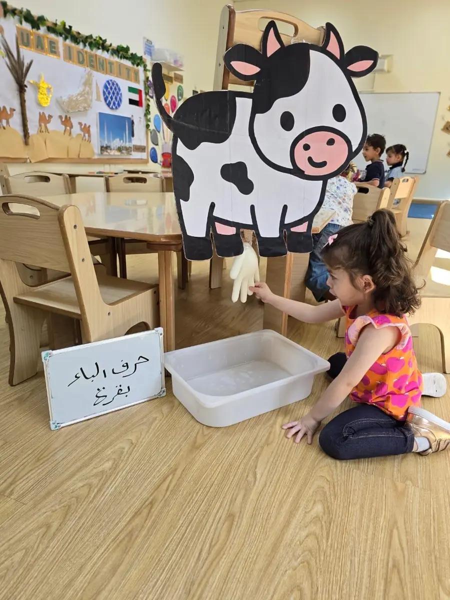 Child exploring a farm-themed sensory activity in class