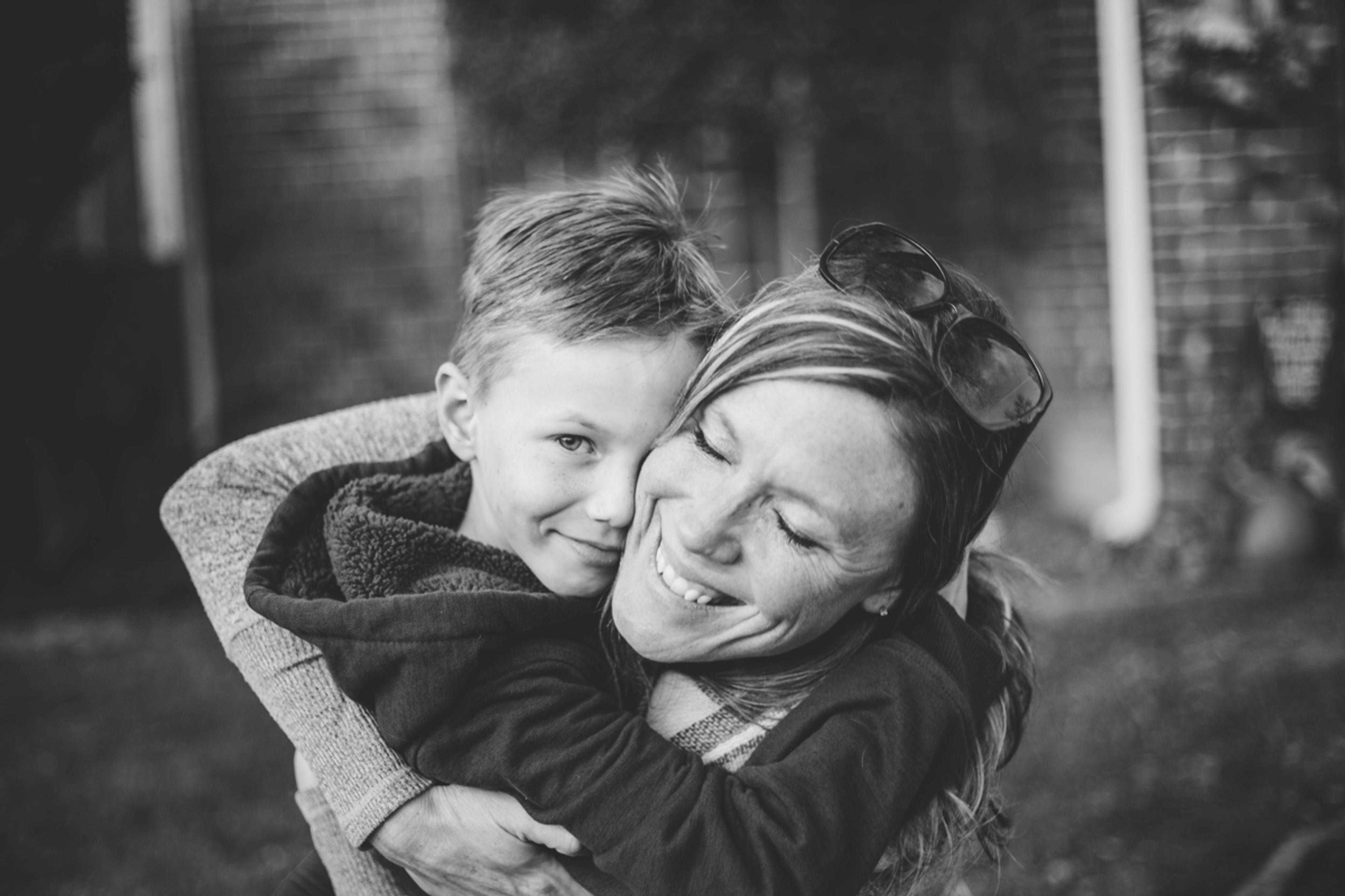 Black-and-white photo of a mom hugging her young son