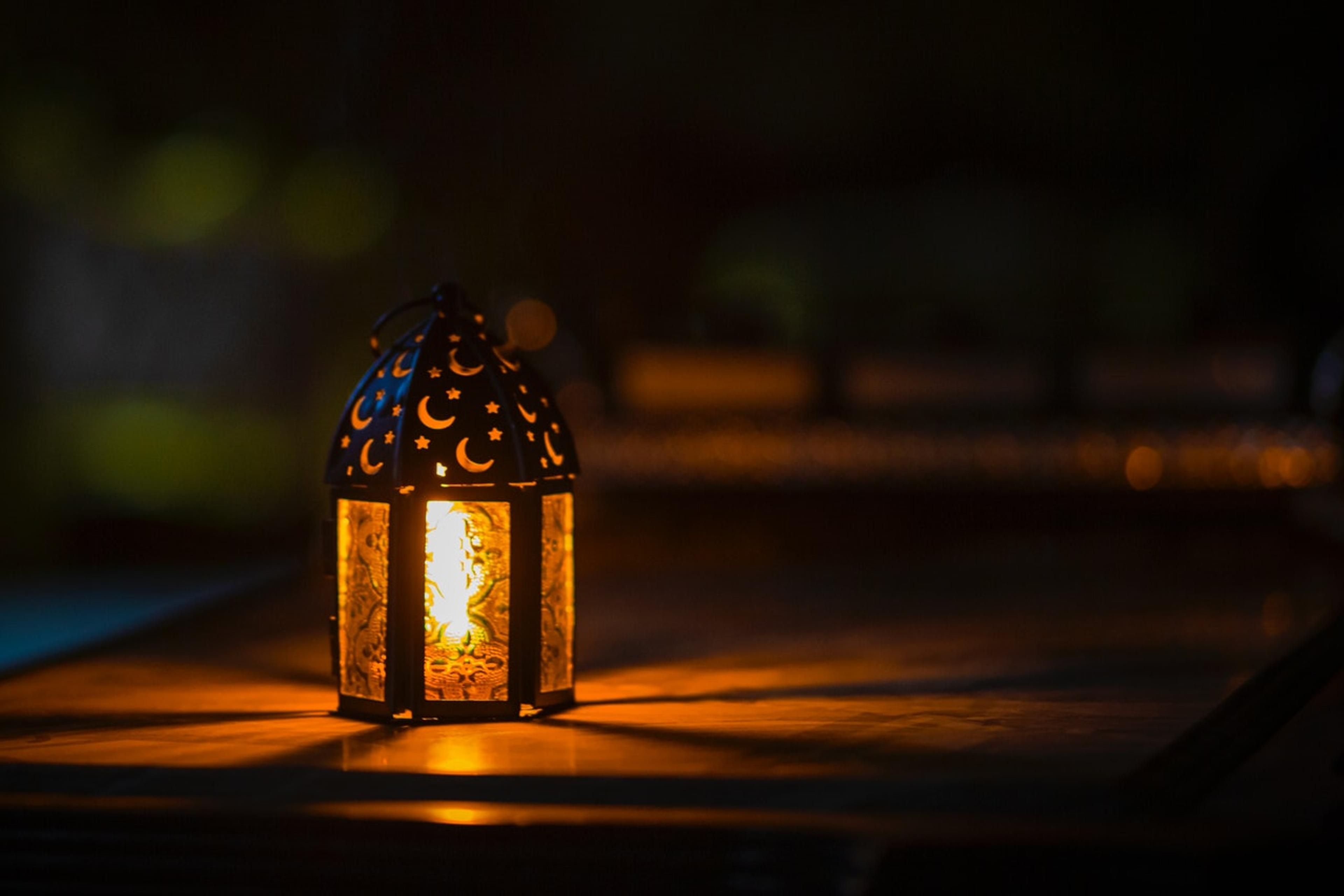 A lit candle on a dark background