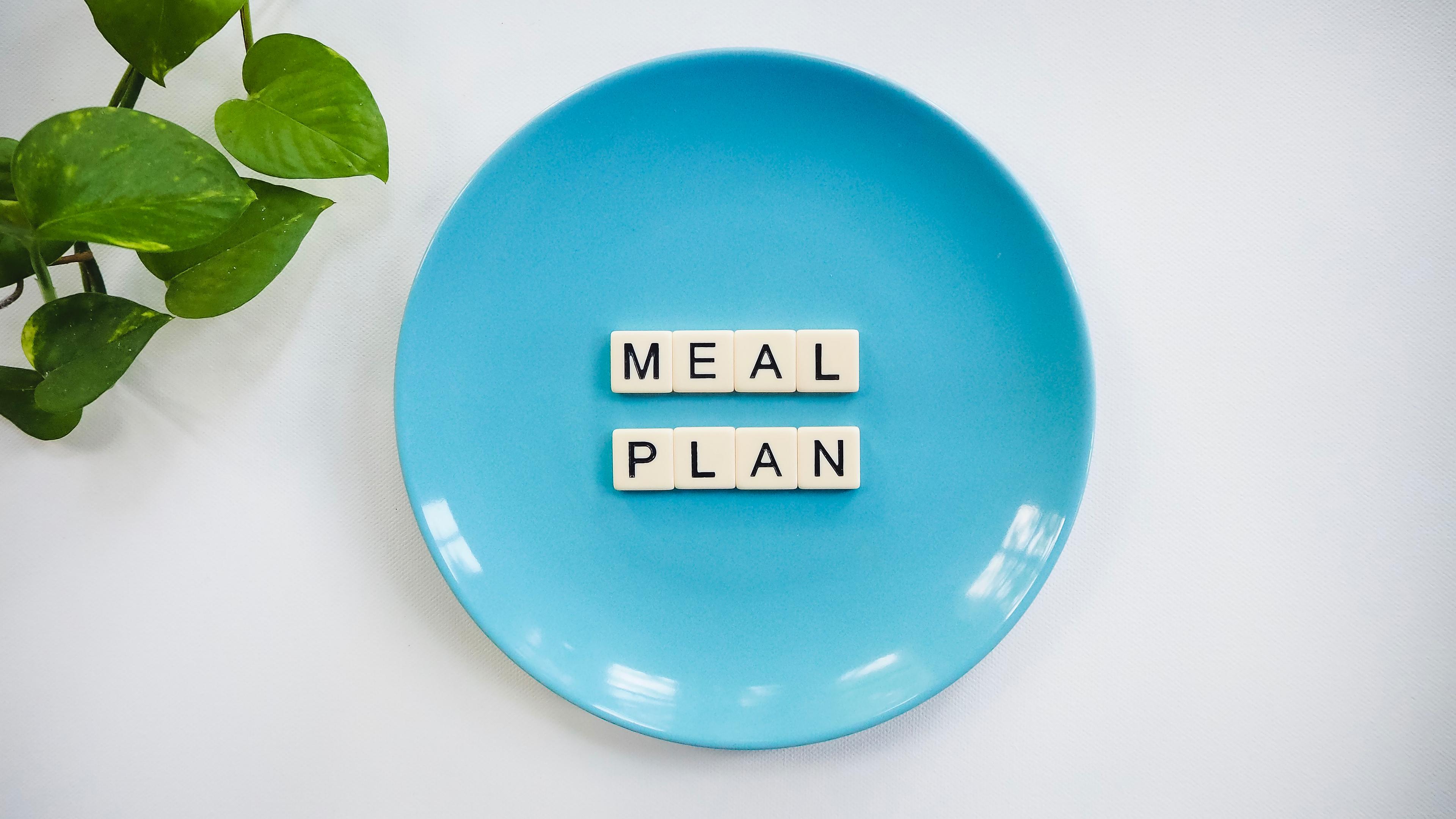 A blue plate with the words "Meal Plan" on it in tiles