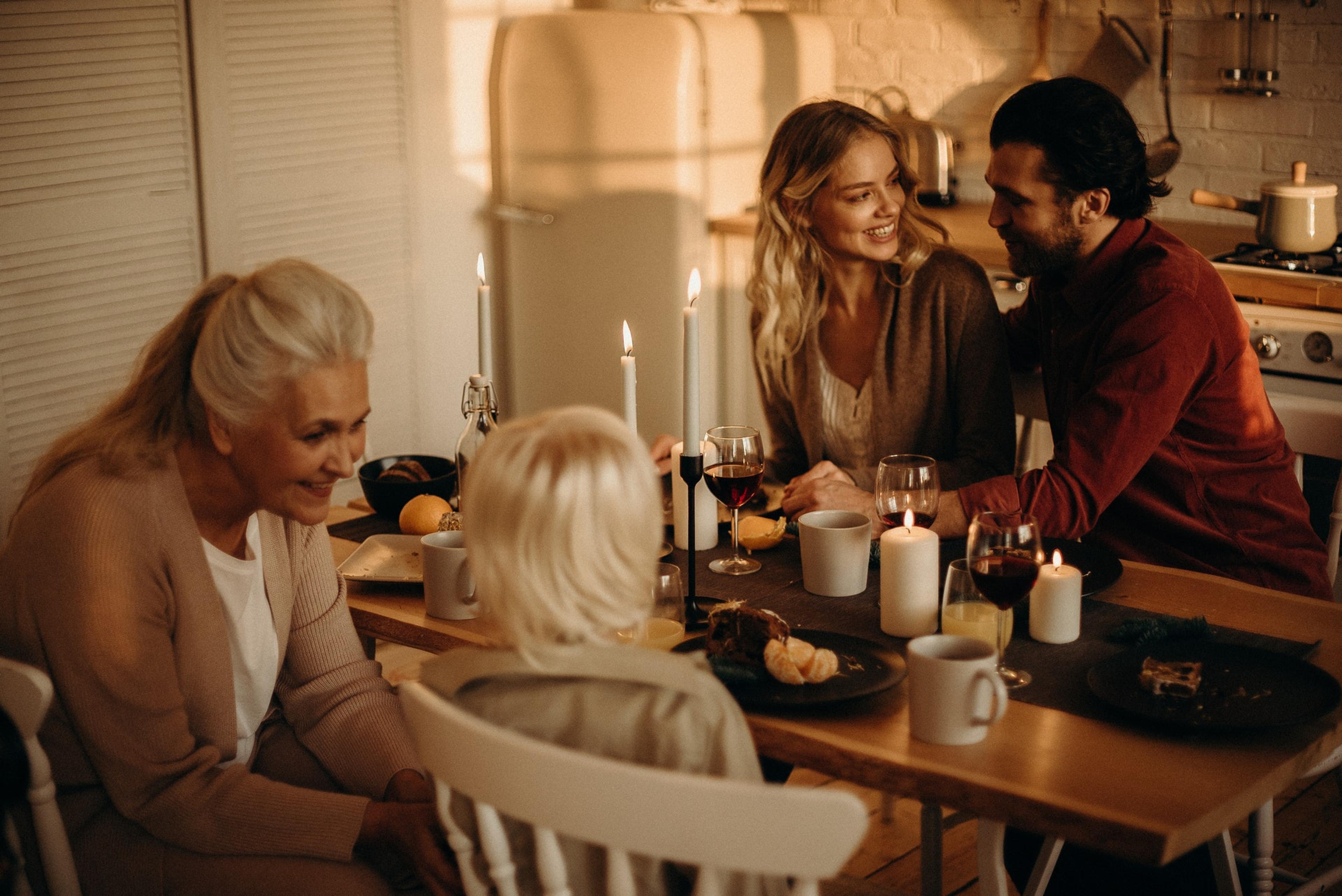 A family gathers around a kitchen table