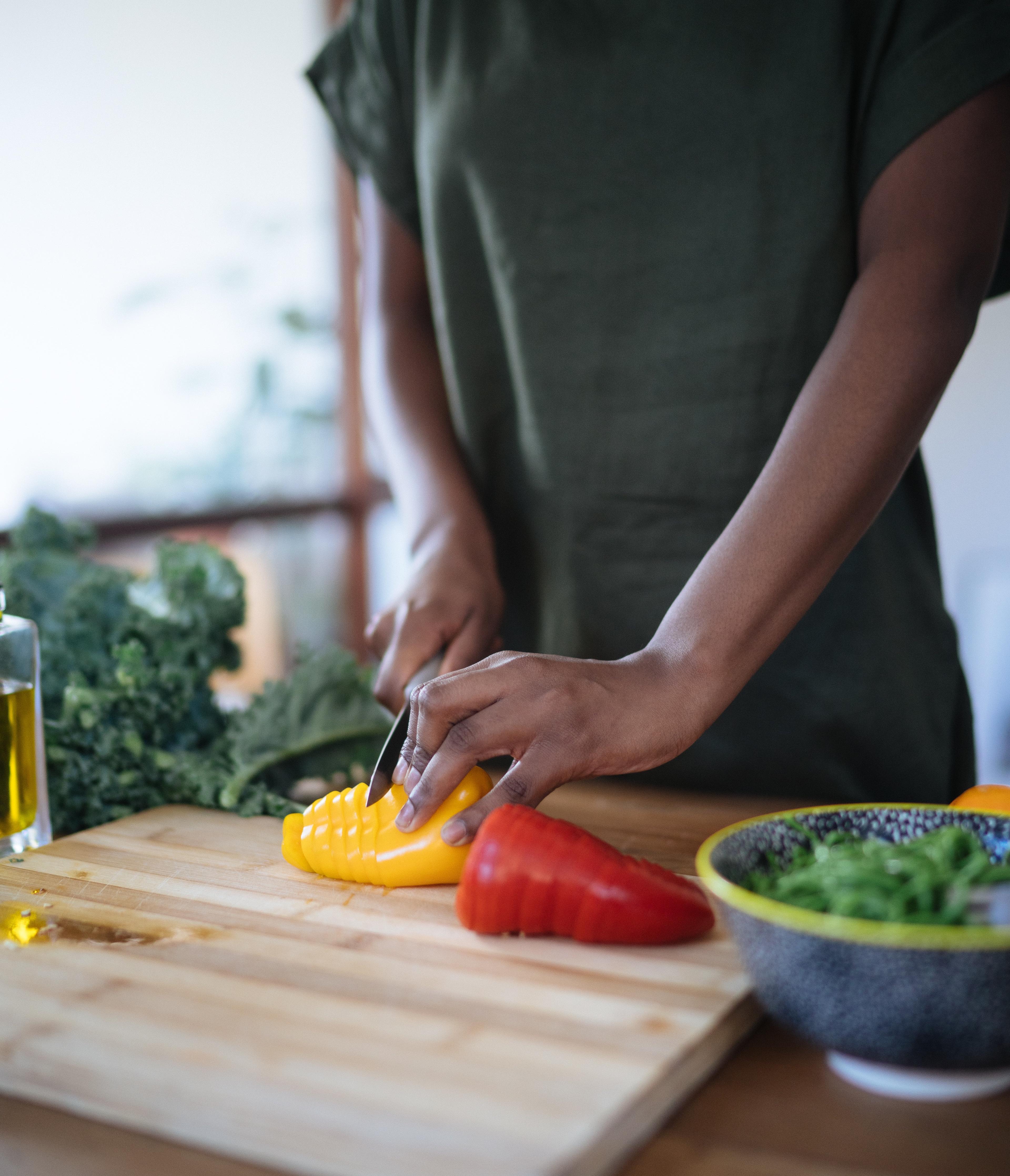 Person chopping tomatoes making a salad