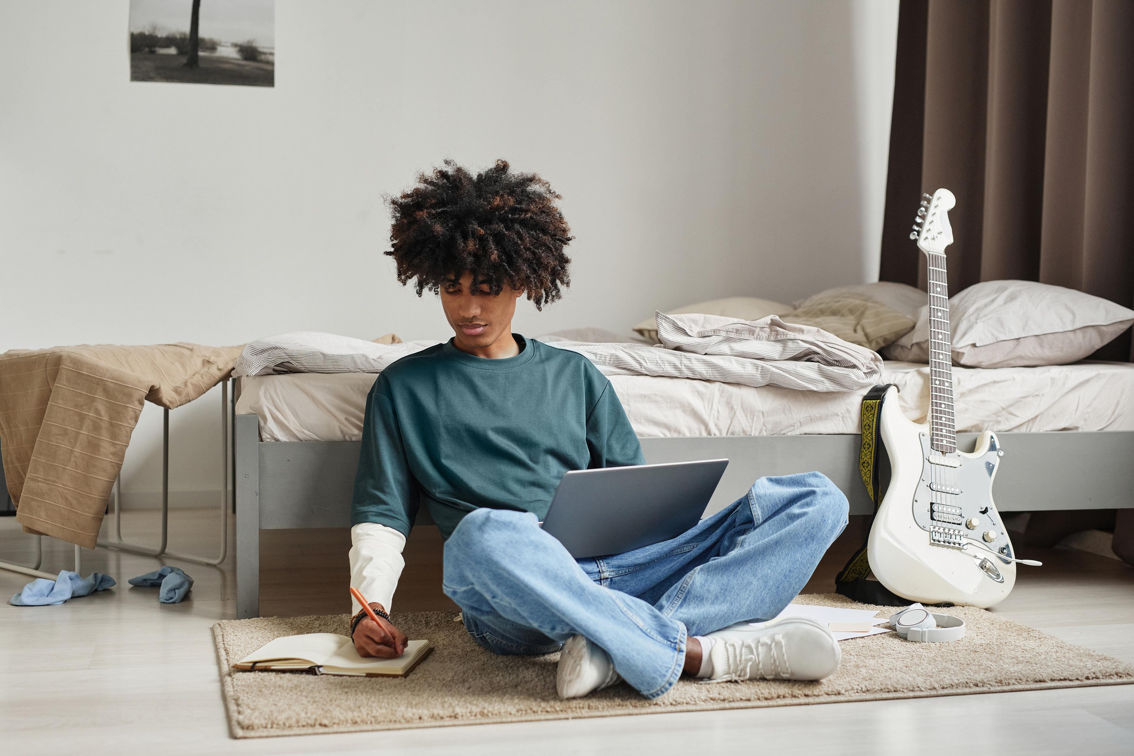 boy in room doing homework