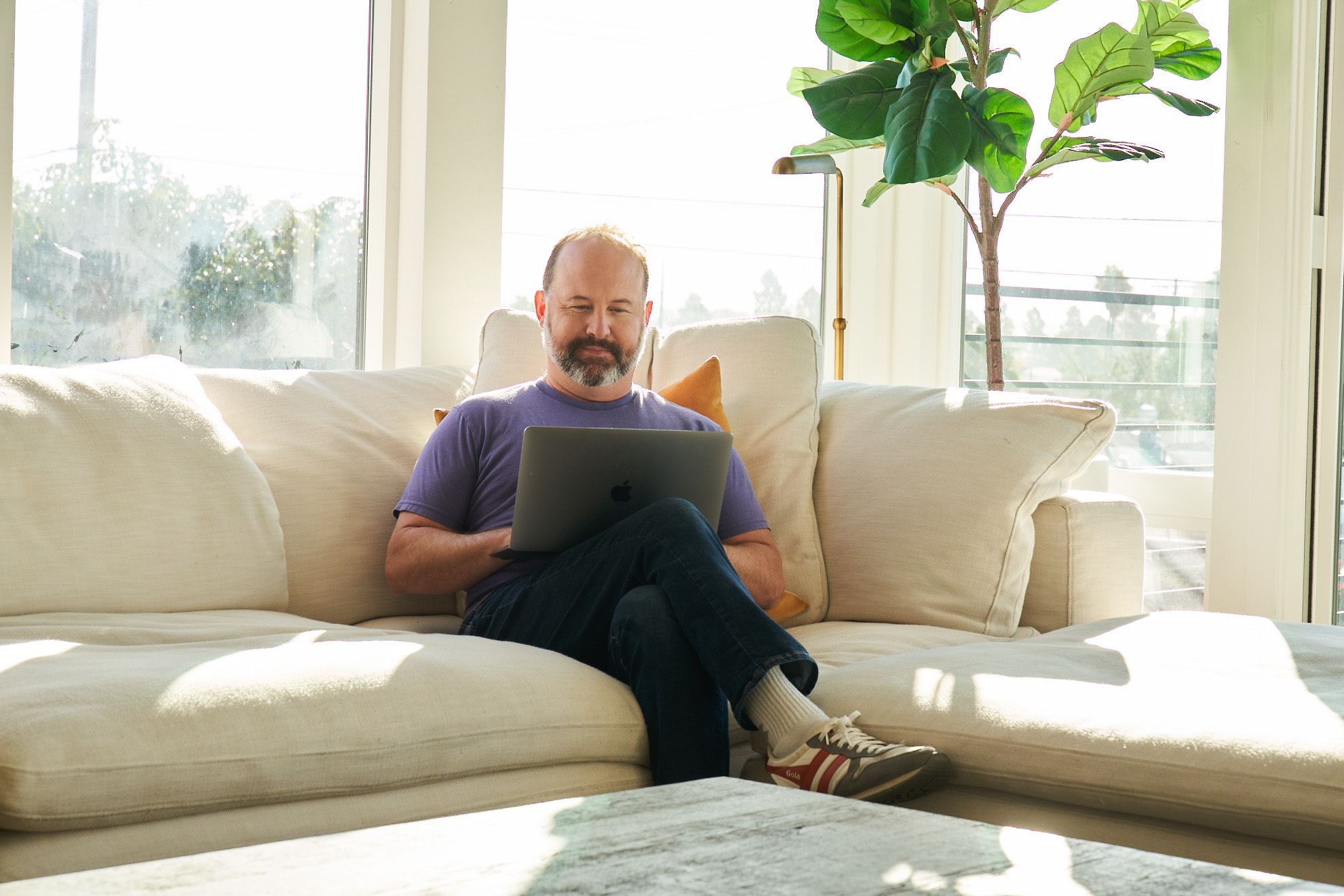 Man sitting on couch on the computer