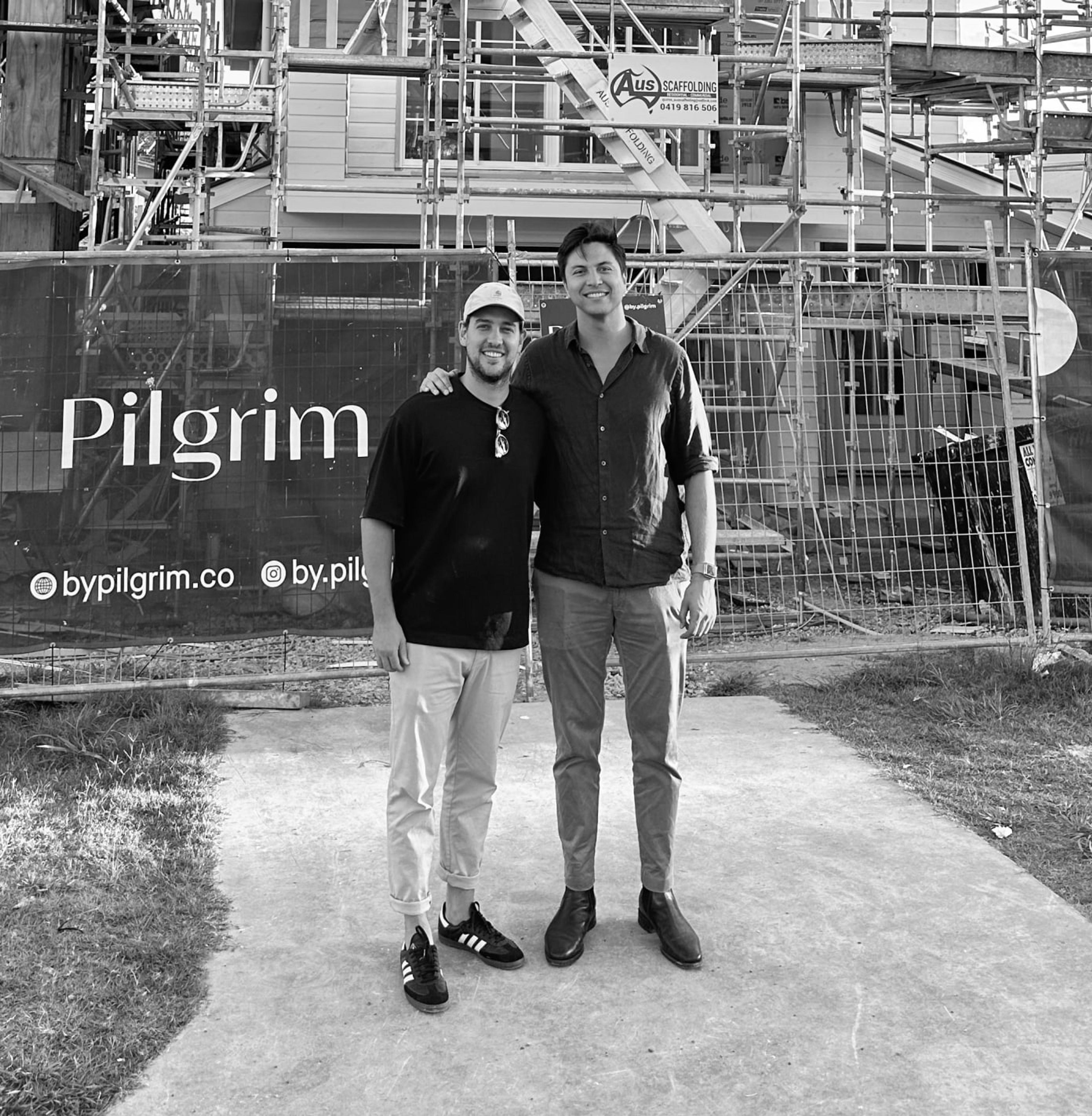 Caleb and John in front of a new build site