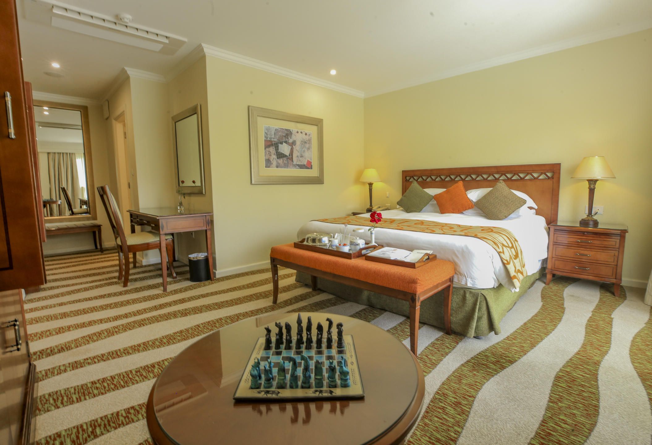 Executive suite bedroom with double bed and table with chess board