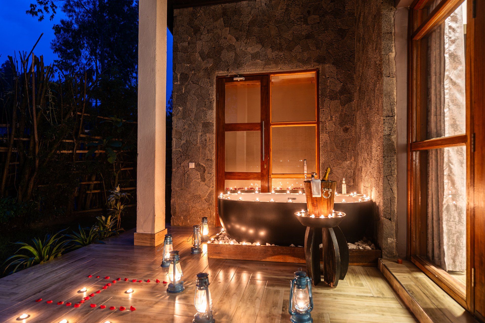 Veranda with bathtub surrounded by candles