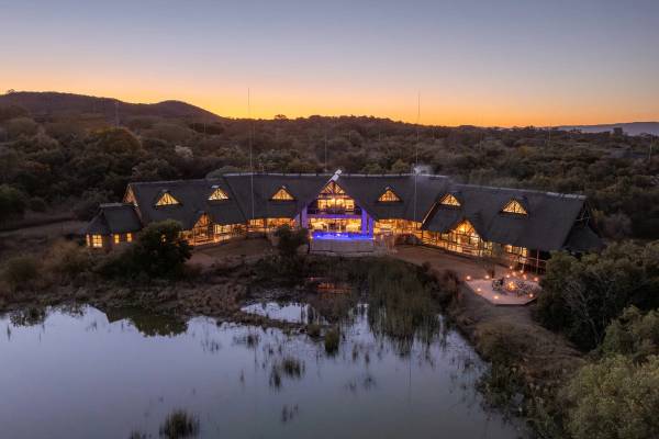 View of Kingfisher Villa overlooking lake after sunset