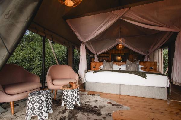 Bedroom with double four poster bed and two armchairs