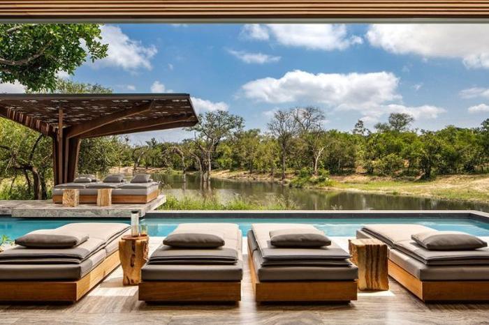 Loungers beside a pool overlooking Sabi Sand game reserve