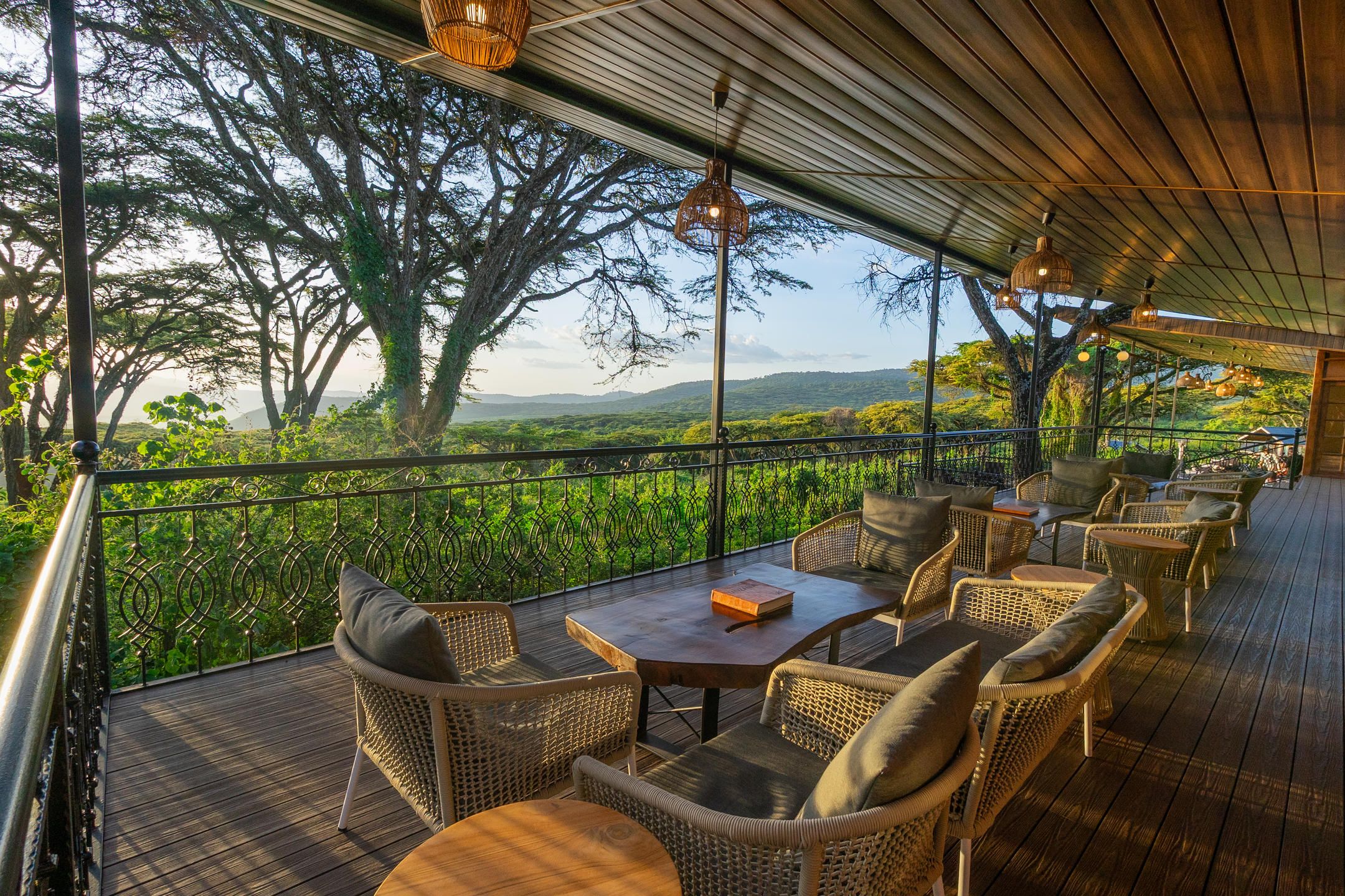 Wooden deck with outdoor loungers and table overlooking Ngorongoro Crater