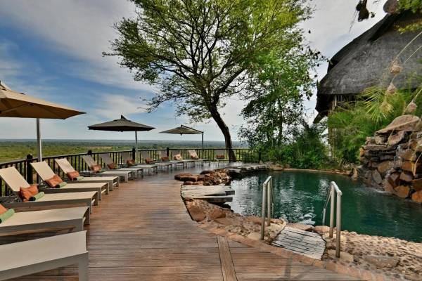 Victoria Falls safari lodge poolside with loungers