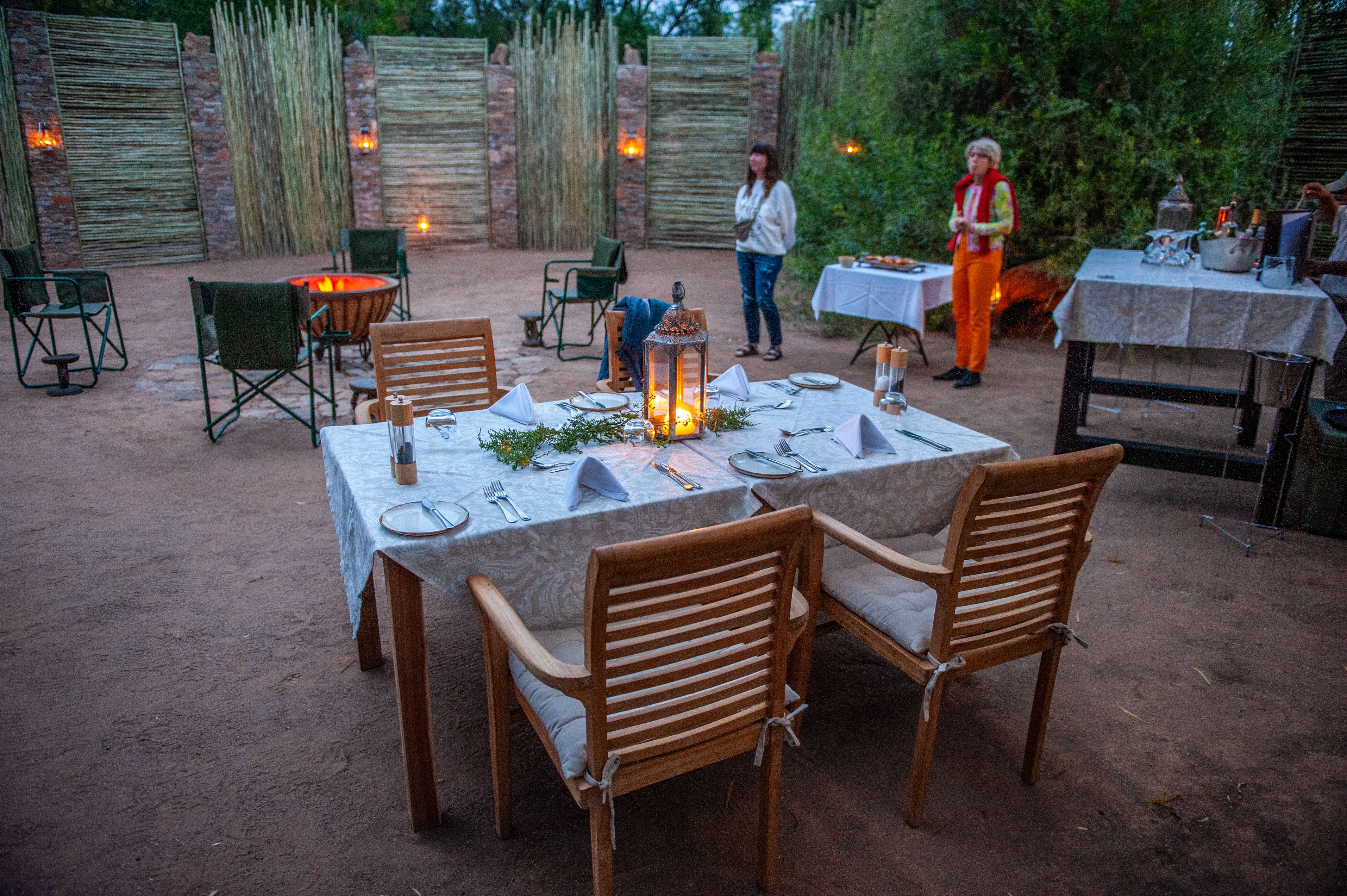 A table laid ready for dinner in a boma.