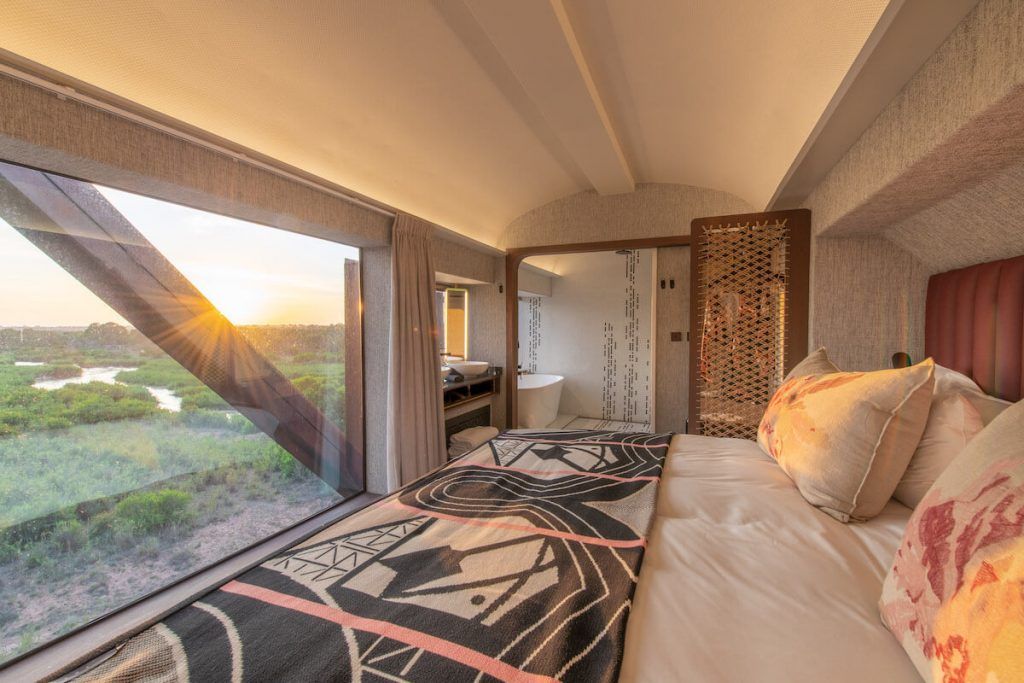 Kruger Shalati carriage room with bed overlooking floor to ceiling window