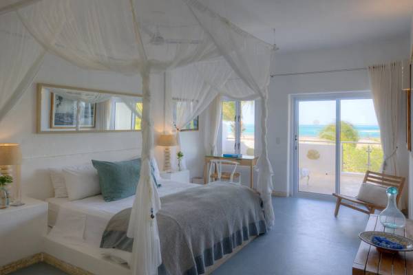 Hotel suite with four poster double bed and mosquito net