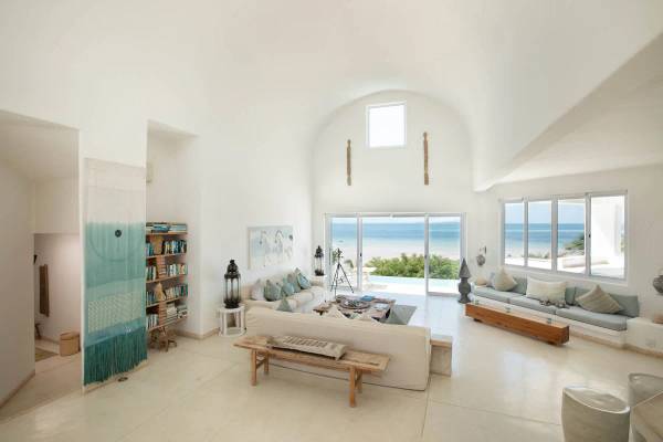 Santorini Mozambique main villa lounge area with sofas and triple volume ceiling