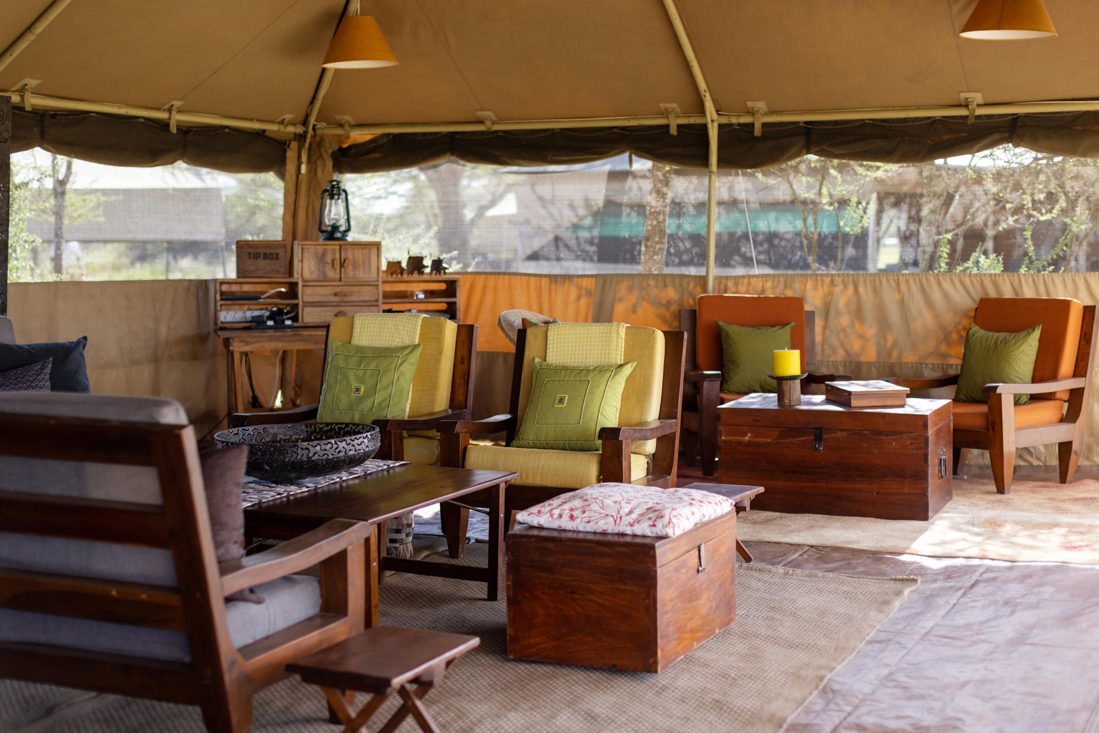 Armchairs and sofas in tented luxury lounge area