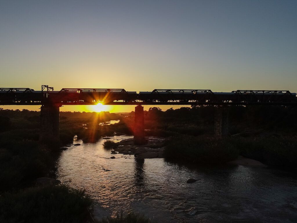 Silhouette of Kruger Shalati Train on the Bridge with sunsetting
