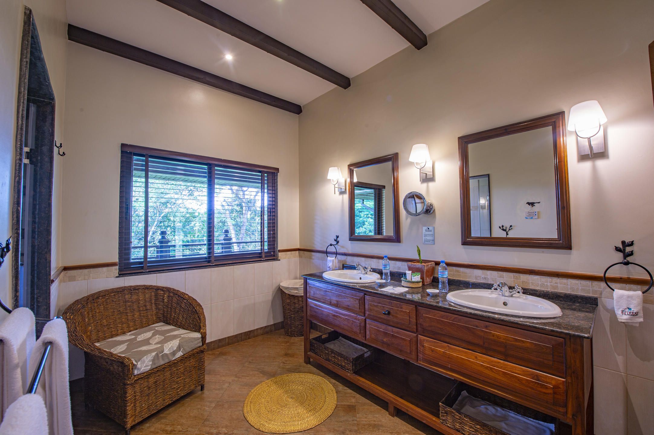 Bathroom with double basins and armchair