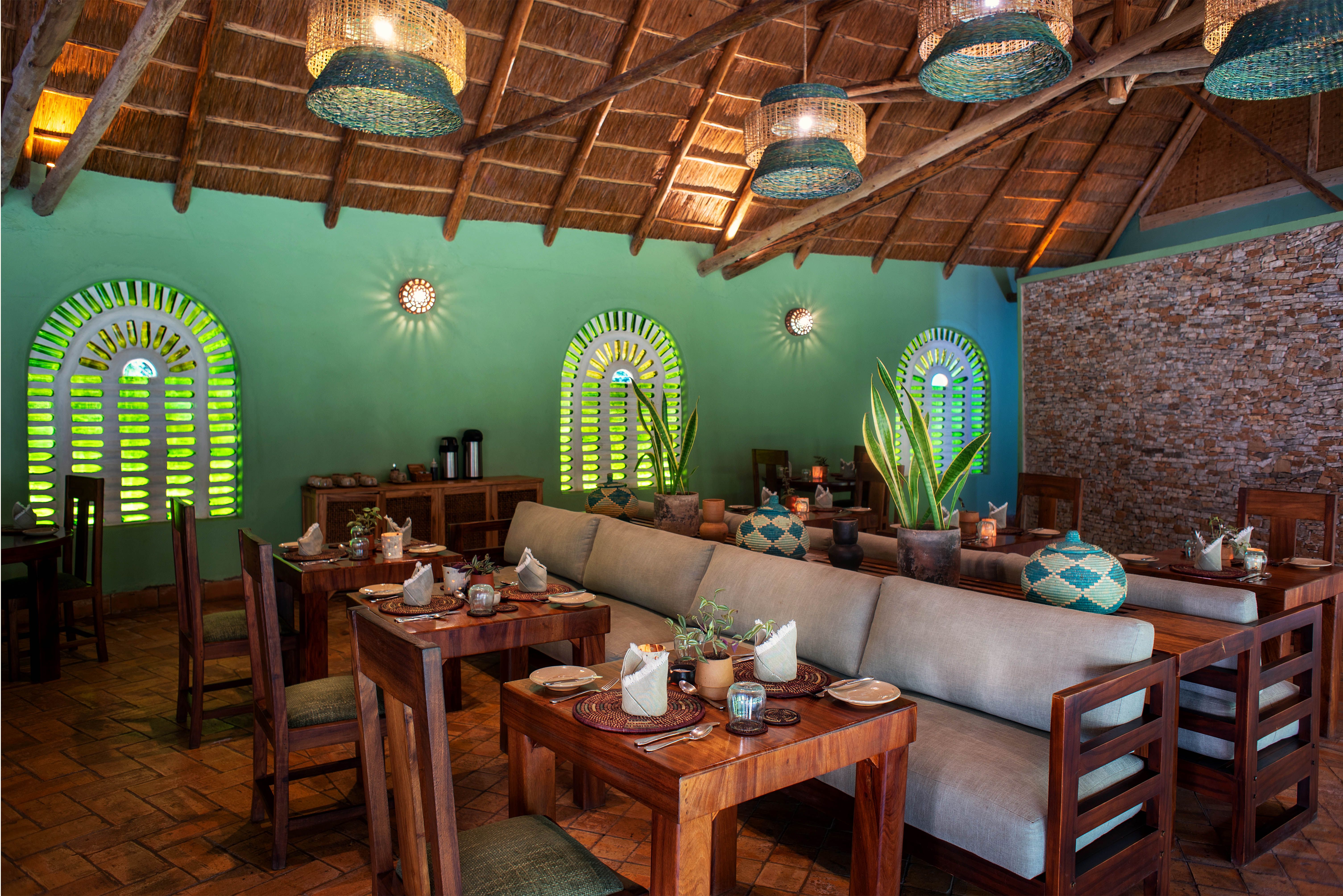 Restaurant with wooden tables chairs and sofa benches