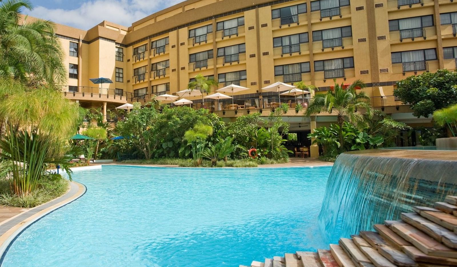 Courtyard with pool of three story hotel complex Kigali Serena Hotel