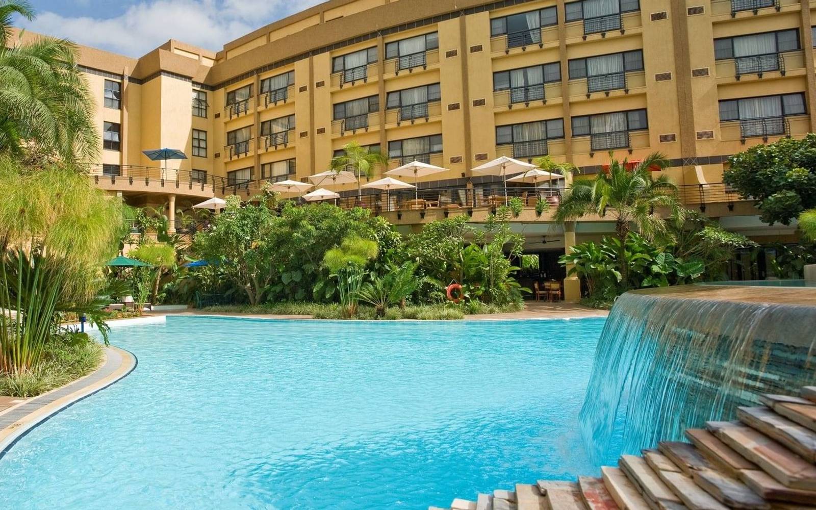 Courtyard with pool of three story hotel complex Kigali Serena Hotel