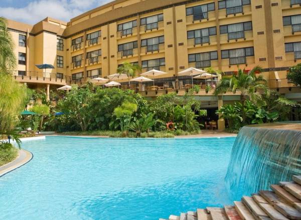 Courtyard with pool of three story hotel complex Kigali Serena Hotel