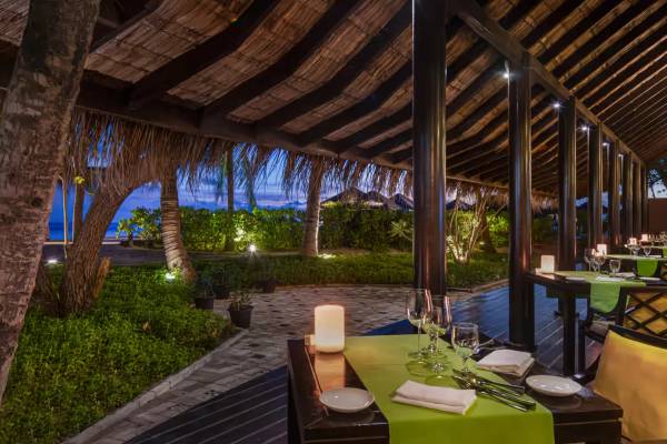 Wooden chalet with candle lit dining tables