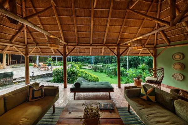 Lounge with sofas and coffee table overlooking green garden