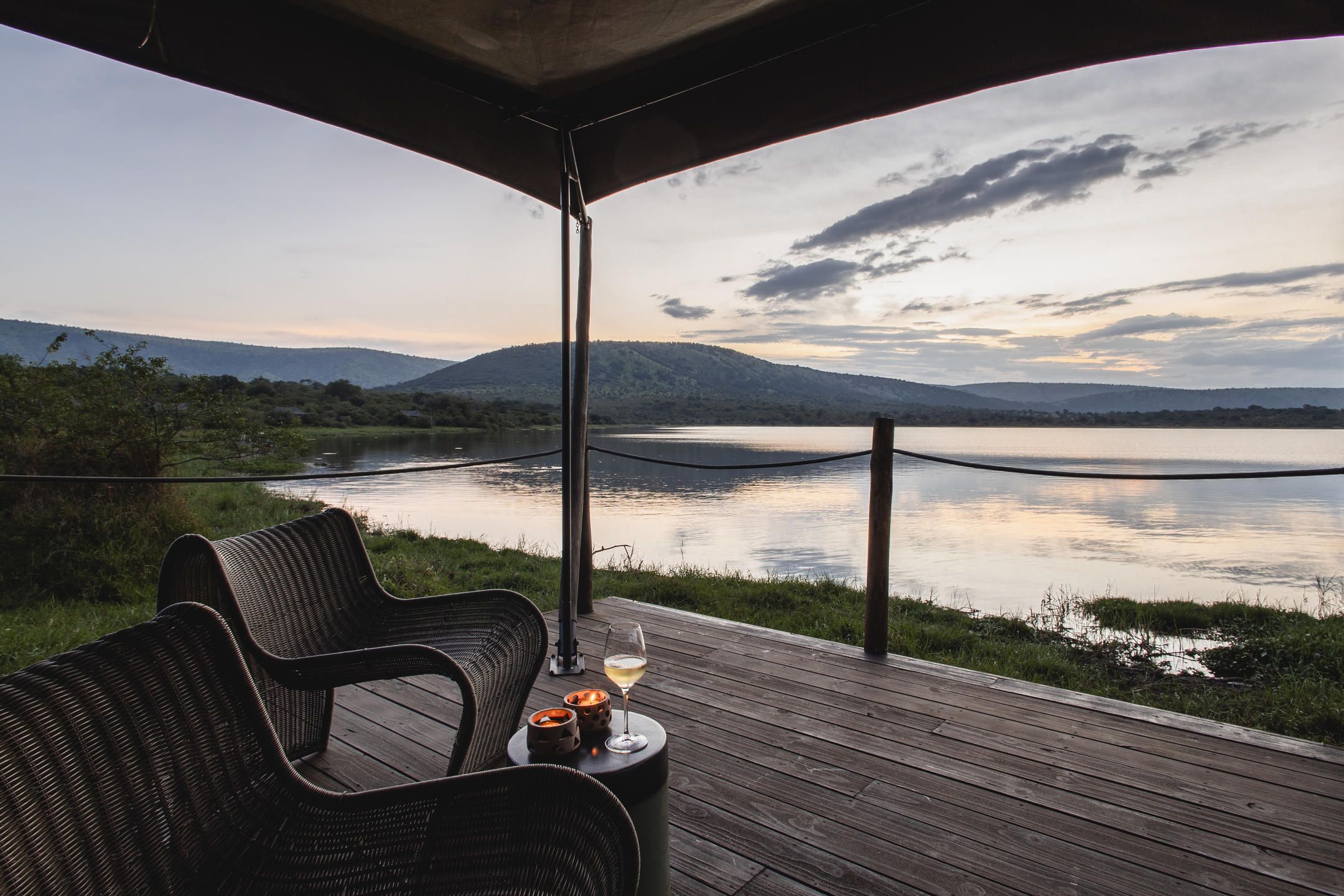View over Lake Rwanyakazinga from luxury tented room veranda with deck chairs